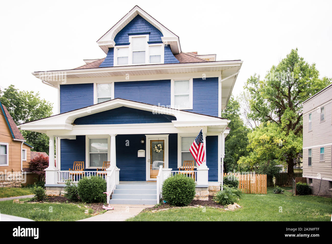 Beautiful navy blue colonial with large front porch in historic Dougherty neighborhood, Independence Missouri Stock Photo