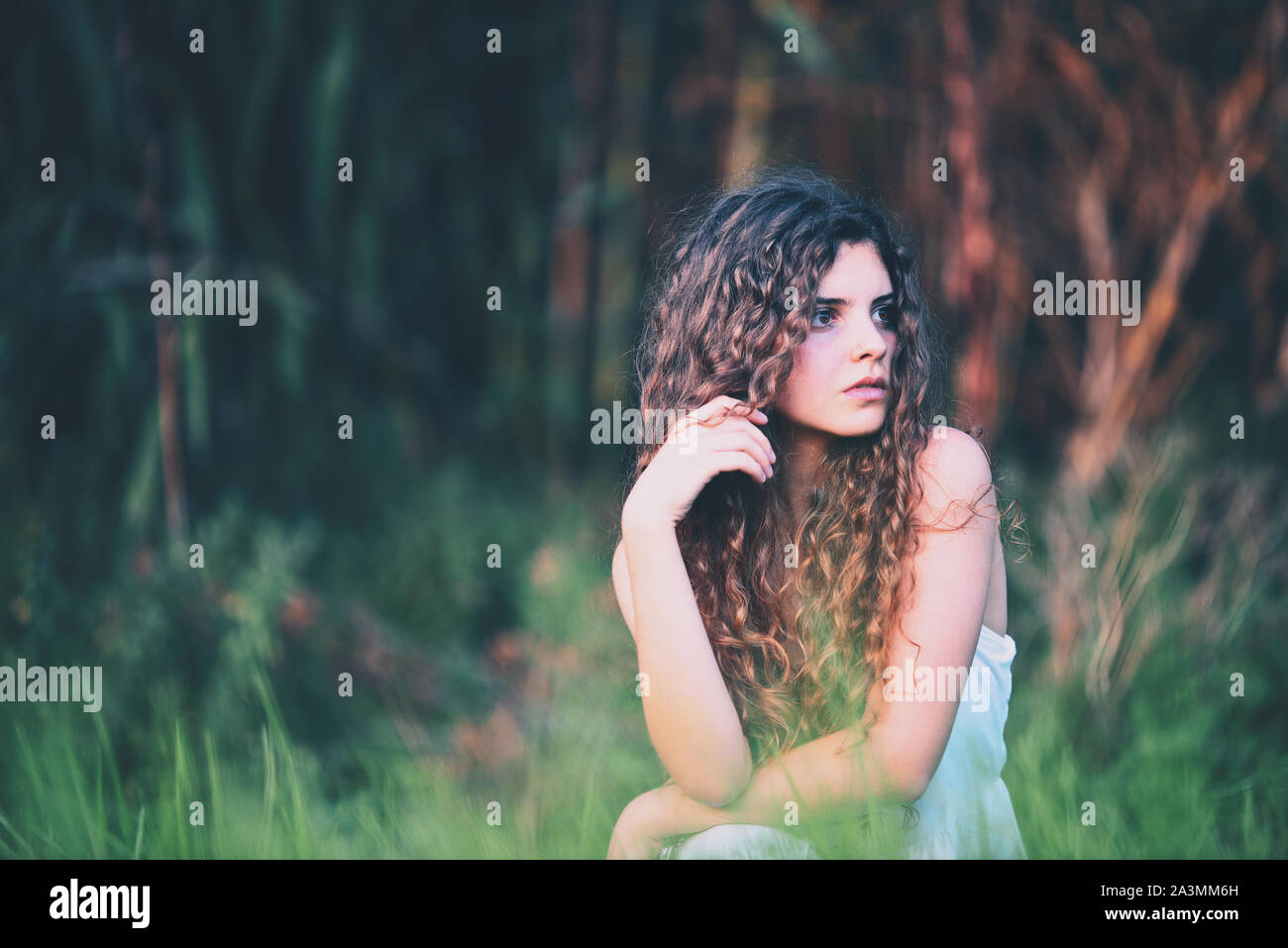 beautiful young woman with long curly hair Stock Photo - Alamy