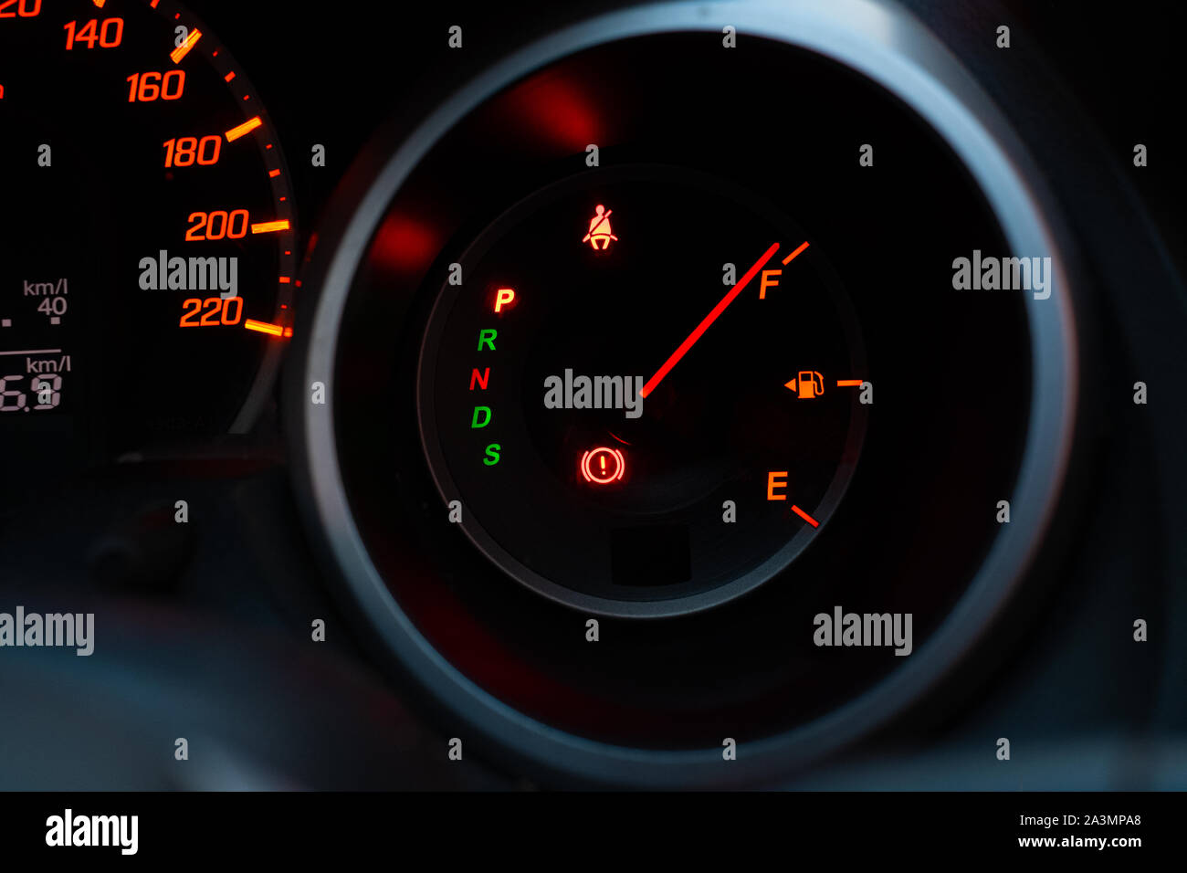 Close up of meter panel with the needle pointing at F on black