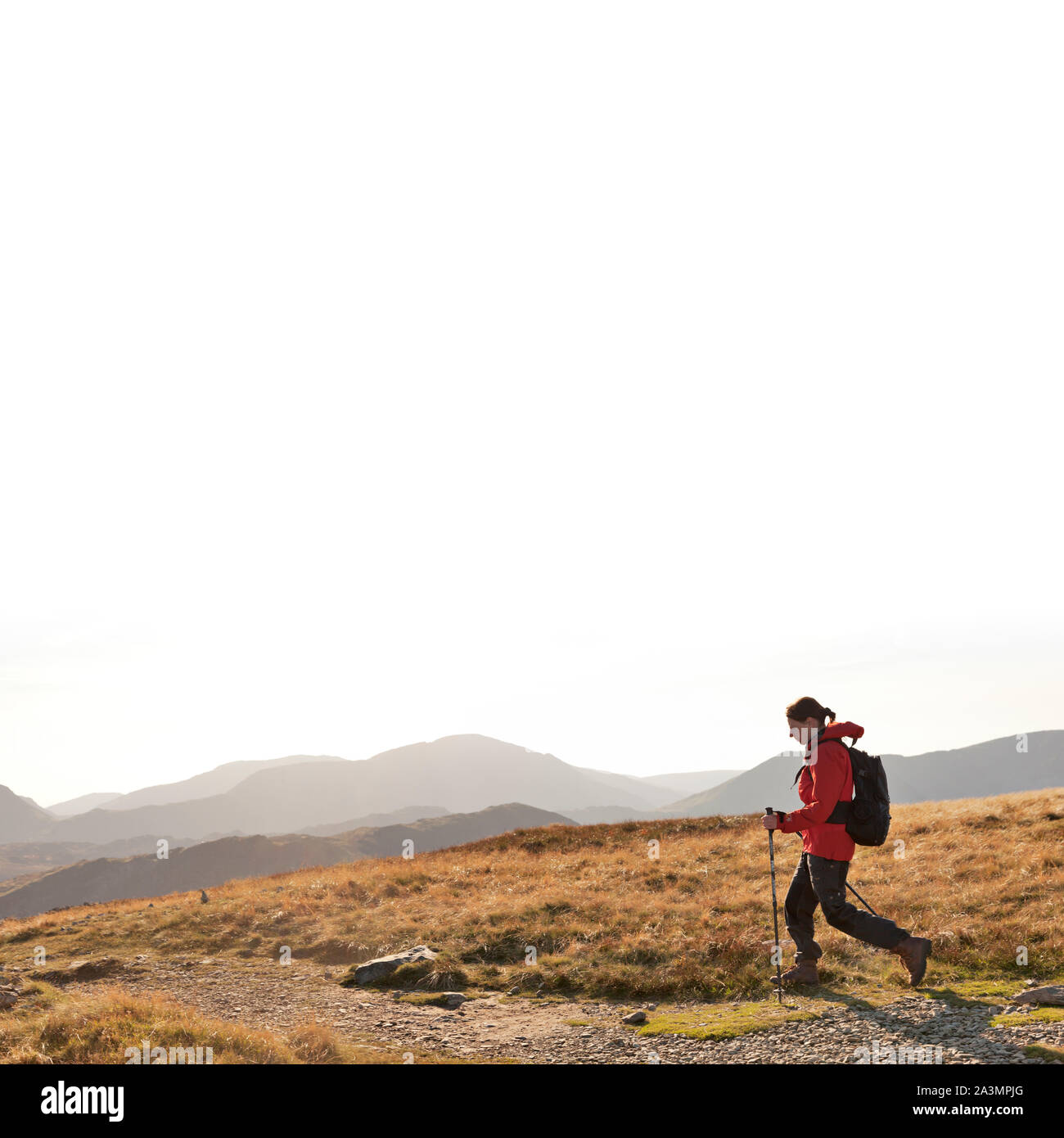 Woman hiking from Dale Head to the Honister Pass in the Lake District. Stock Photo