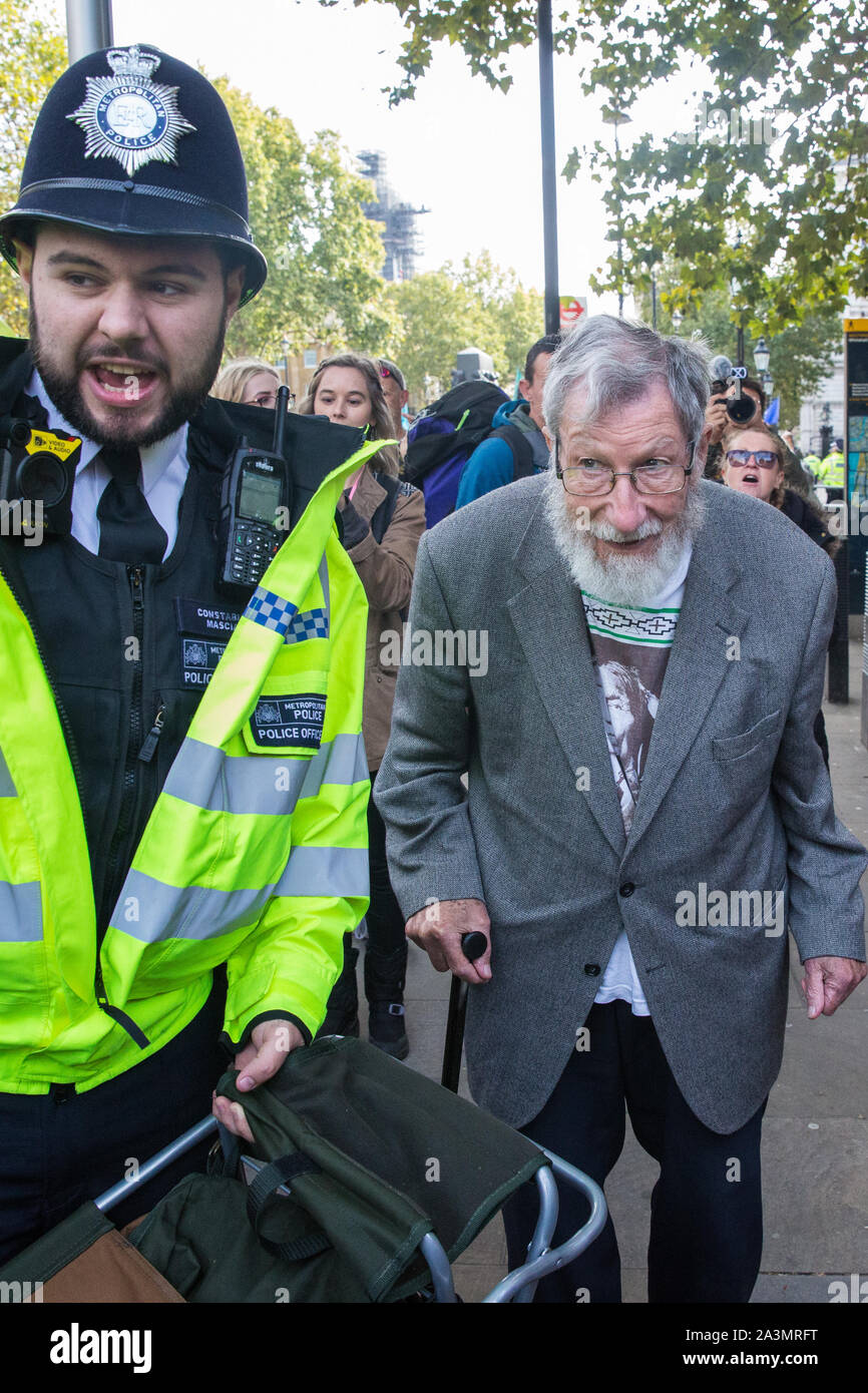 London, UK. 9 October, 2019. John Lynes, a 91-year-old climate activist from Extinction Rebellion is arrested by police officers using Section 14 of the Public Order Act 1986 after blocking Whitehall on the third day of International Rebellion protests to demand a government declaration of a climate and ecological emergency, a commitment to halting biodiversity loss and net zero carbon emissions by 2025 and for the government to create and be led by the decisions of a Citizens’ Assembly on climate and ecological justice. Credit: Mark Kerrison/Alamy Live News Stock Photo