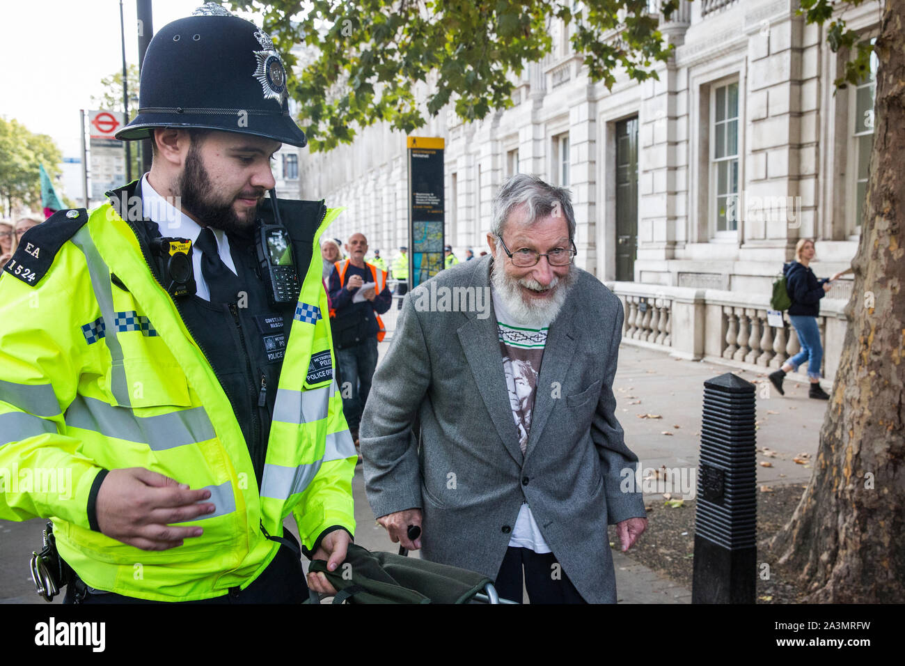 London, UK. 9 October, 2019. John Lynes, a 91-year-old climate activist from Extinction Rebellion is arrested by police officers using Section 14 of the Public Order Act 1986 after blocking Whitehall on the third day of International Rebellion protests to demand a government declaration of a climate and ecological emergency, a commitment to halting biodiversity loss and net zero carbon emissions by 2025 and for the government to create and be led by the decisions of a Citizens’ Assembly on climate and ecological justice. Credit: Mark Kerrison/Alamy Live News Stock Photo