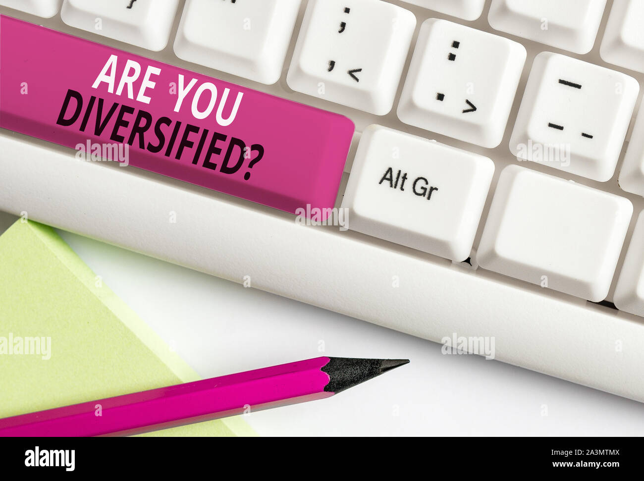 Conceptual hand writing showing Are You Diversified Question. Concept meaning someone who is Different Mixed Multi Faceted White pc keyboard with note Stock Photo