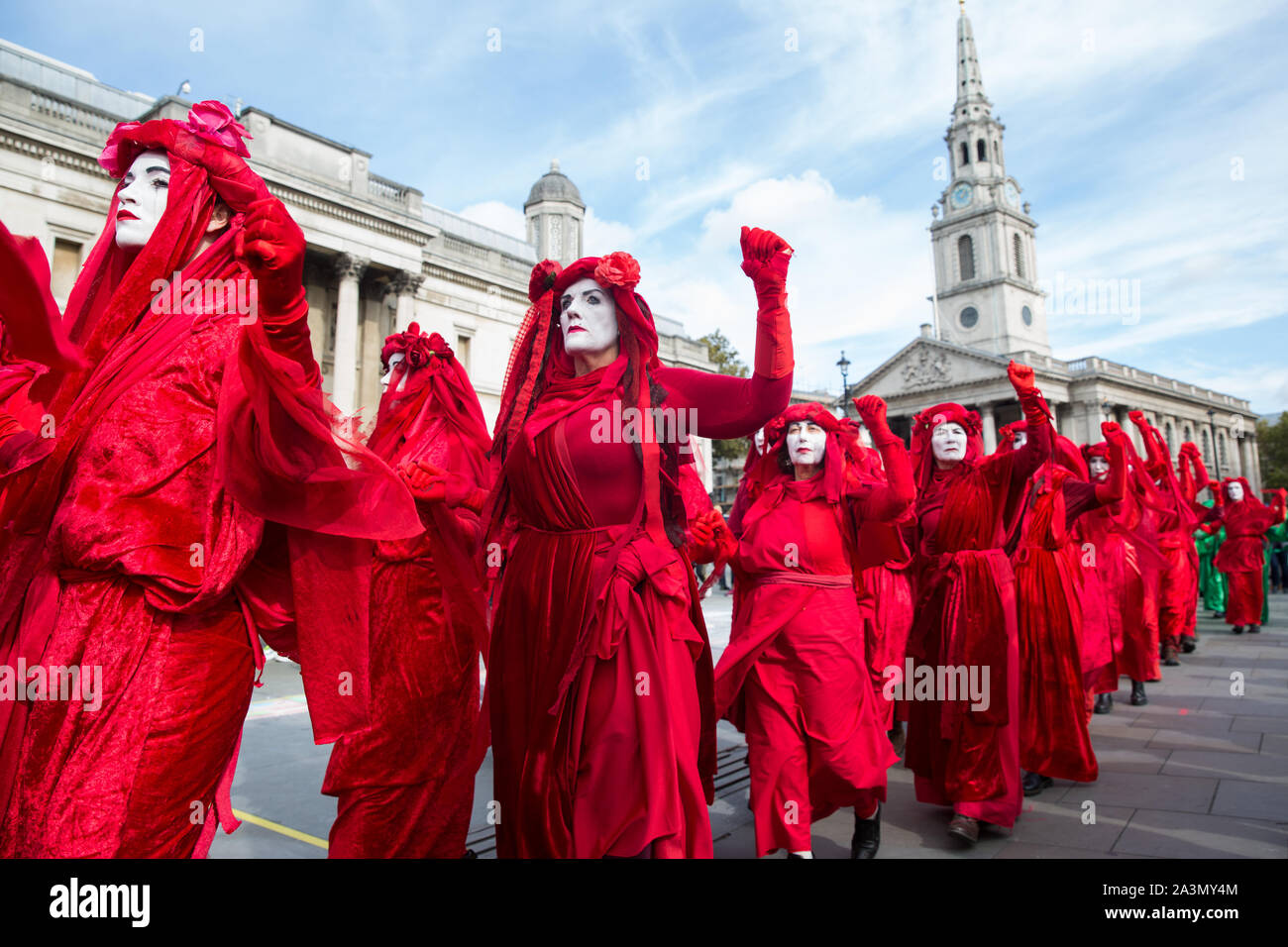 London, UK. 9 October, 2019. Climate activists from the Extinction Rebellion Red Brigade gather in Trafalgar Square on the third day of International Rebellion protests to demand a government declaration of a climate and ecological emergency, a commitment to halting biodiversity loss and net zero carbon emissions by 2025 and for the government to create and be led by the decisions of a Citizens’ Assembly on climate and ecological justice. Credit: Mark Kerrison/Alamy Live News Stock Photo
