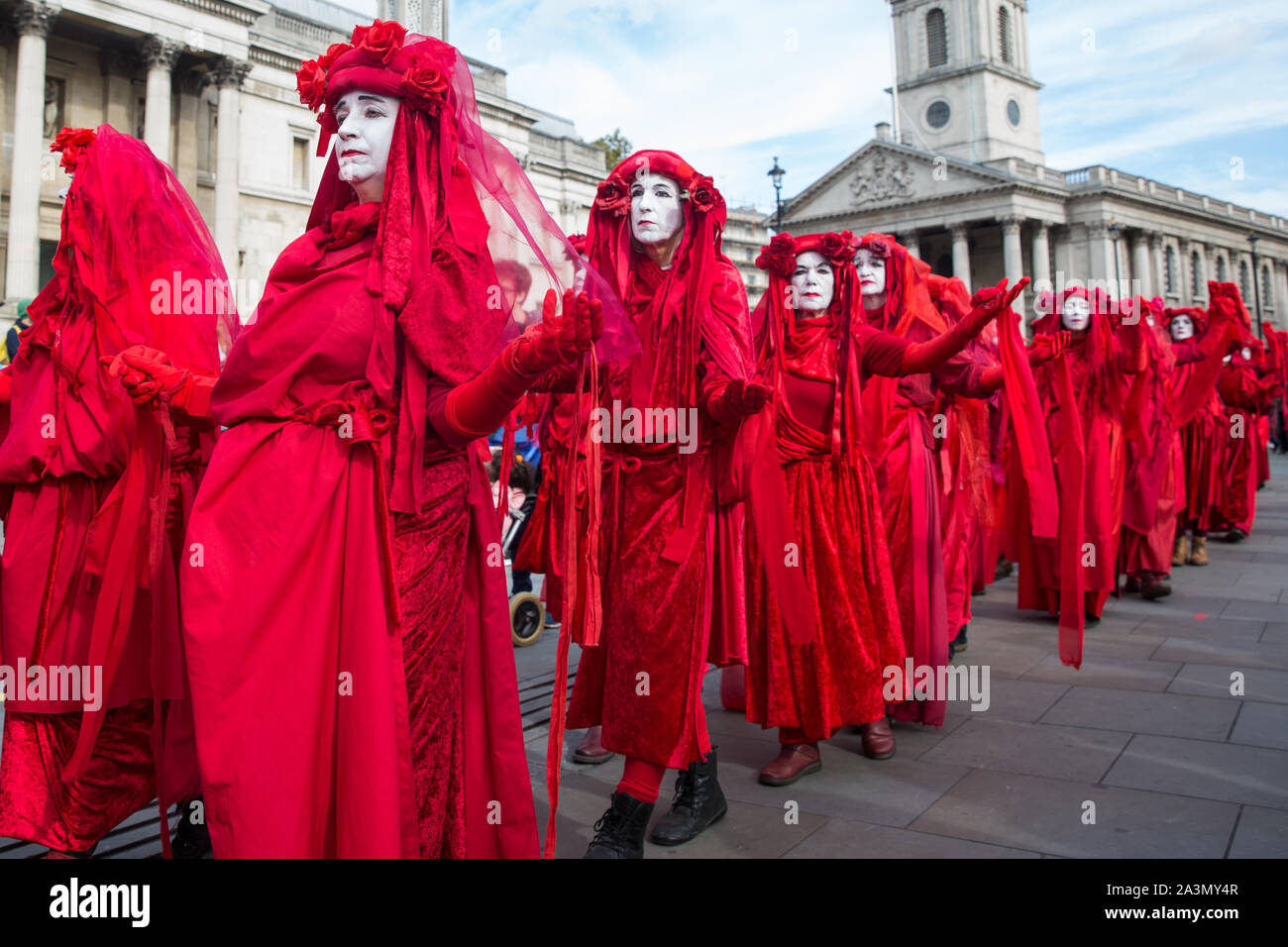 London, UK. 9 October, 2019. Climate activists from the Extinction Rebellion Red Brigade gather in Trafalgar Square on the third day of International Rebellion protests to demand a government declaration of a climate and ecological emergency, a commitment to halting biodiversity loss and net zero carbon emissions by 2025 and for the government to create and be led by the decisions of a Citizens’ Assembly on climate and ecological justice. Credit: Mark Kerrison/Alamy Live News Stock Photo