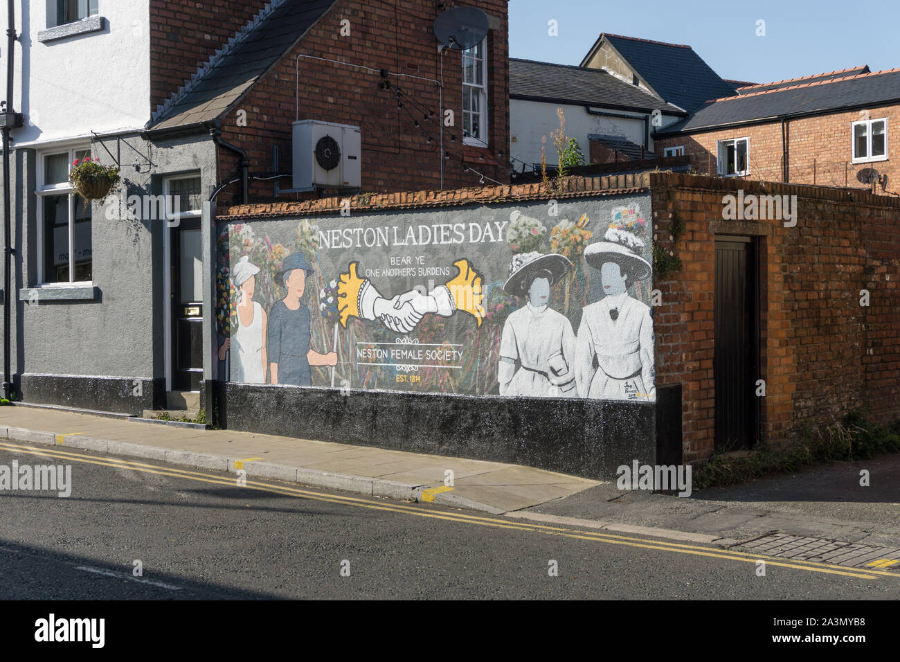 Wall art promoting Neston Ladies Day, an annual event run by the Neston Female Society; Neston, Wirral, Cheshire Stock Photo
