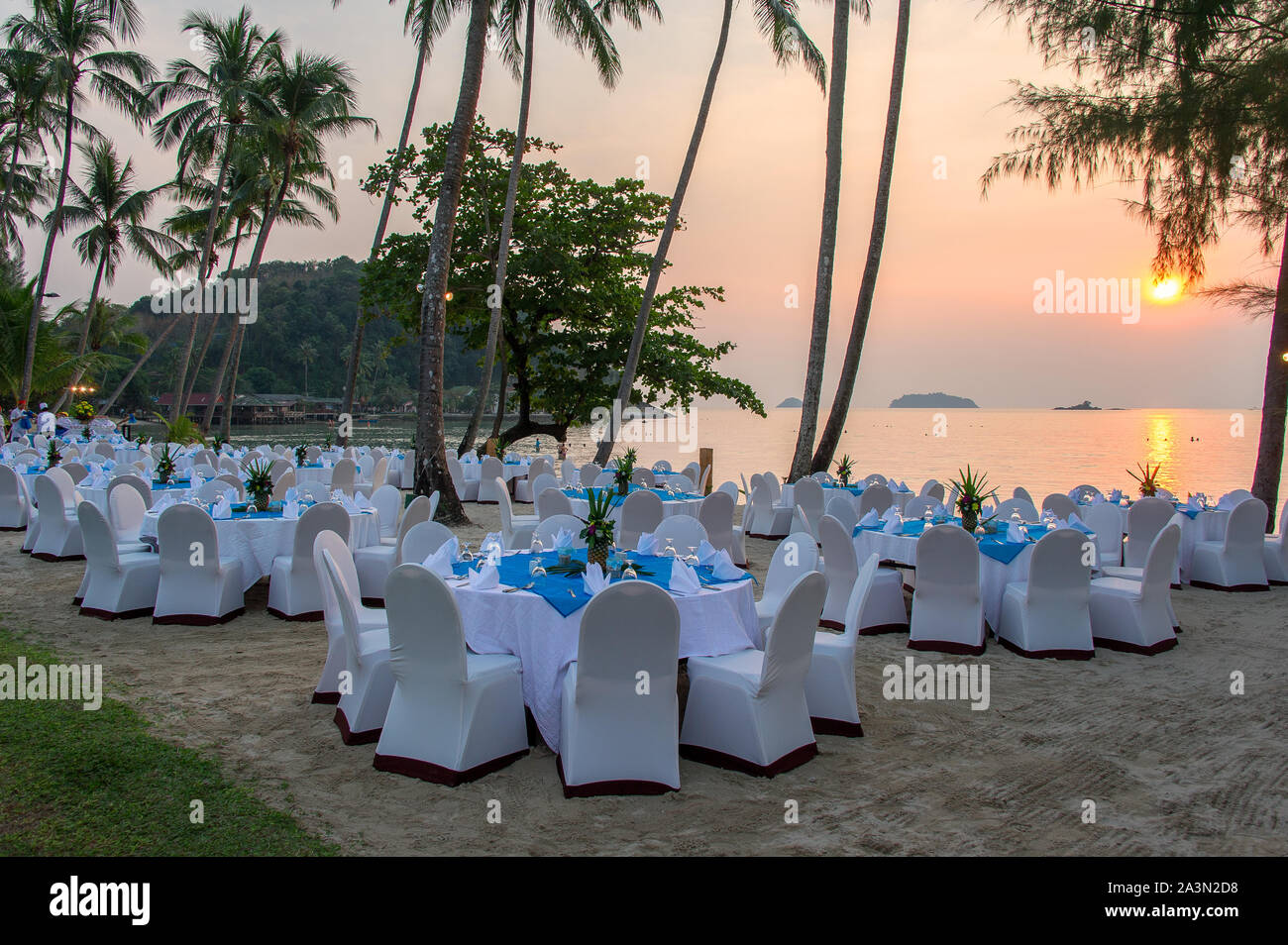 Koh Chang, Thailand - February 2016: tables set for sunset dinner on the beach Stock Photo