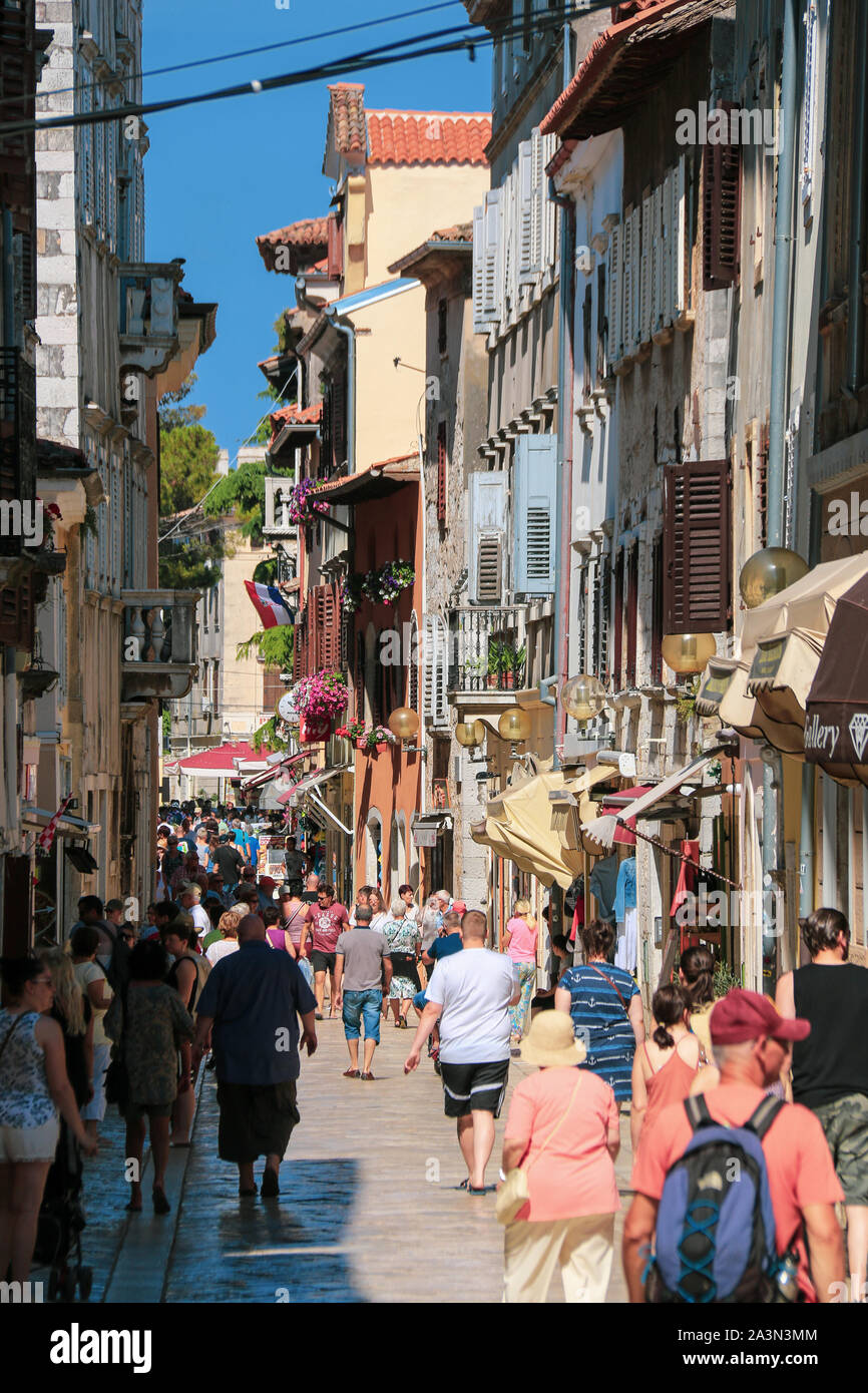View of a bustling narrow alley in the old town of Poreč, Croatia Stock Photo