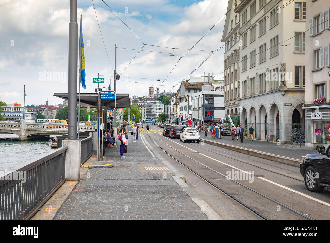 People waiting in Tram stop Rudolf-Brun-Brücke in Zürich, Stock Photo