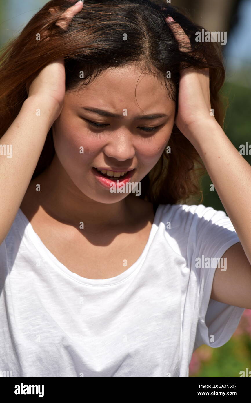 An Anxious Young Asian Adult Female Stock Photo