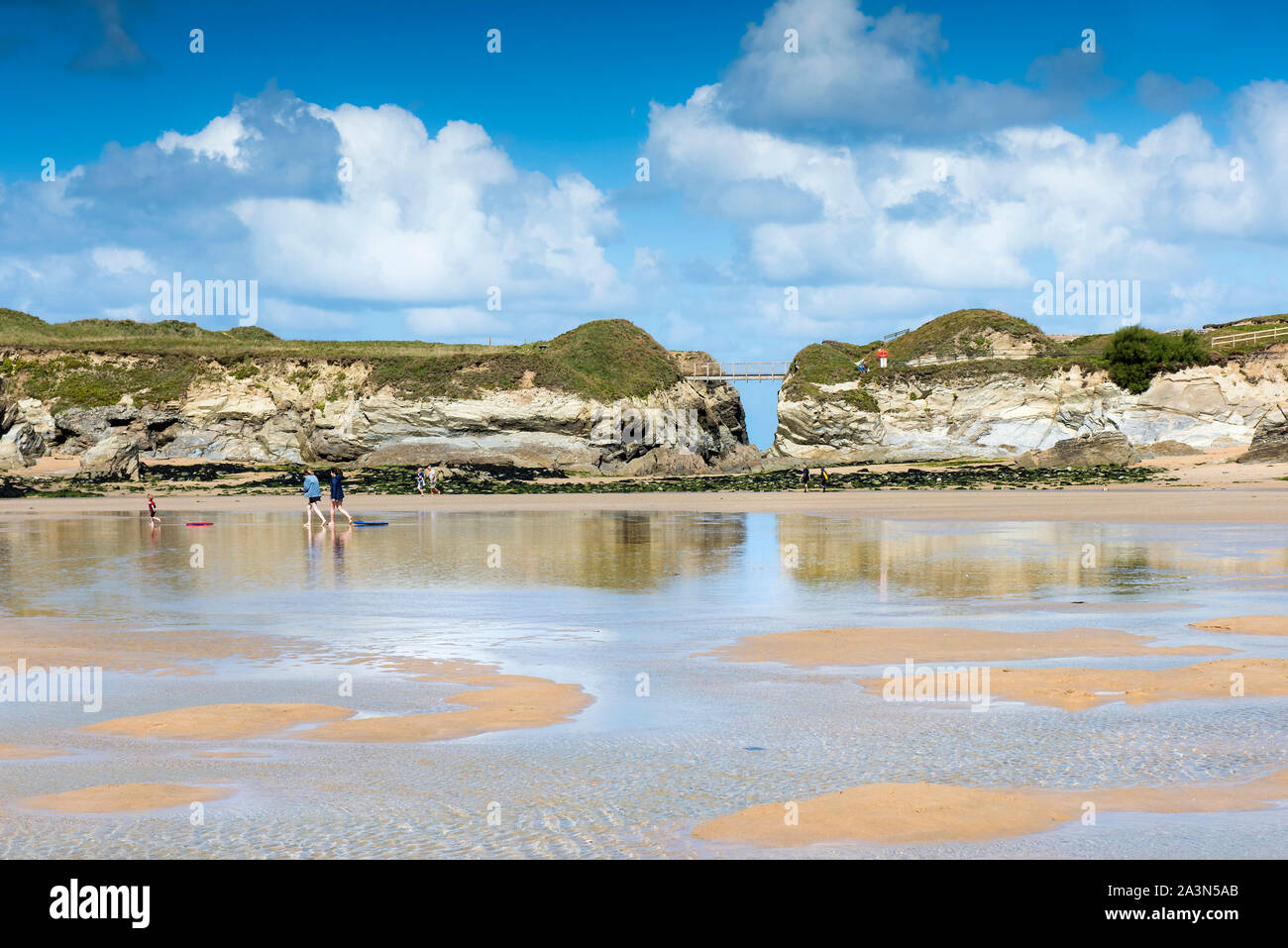 The footbridge connecting the mainland with Porth Island at Porth Beach in Newquay in Cornwall. Stock Photo