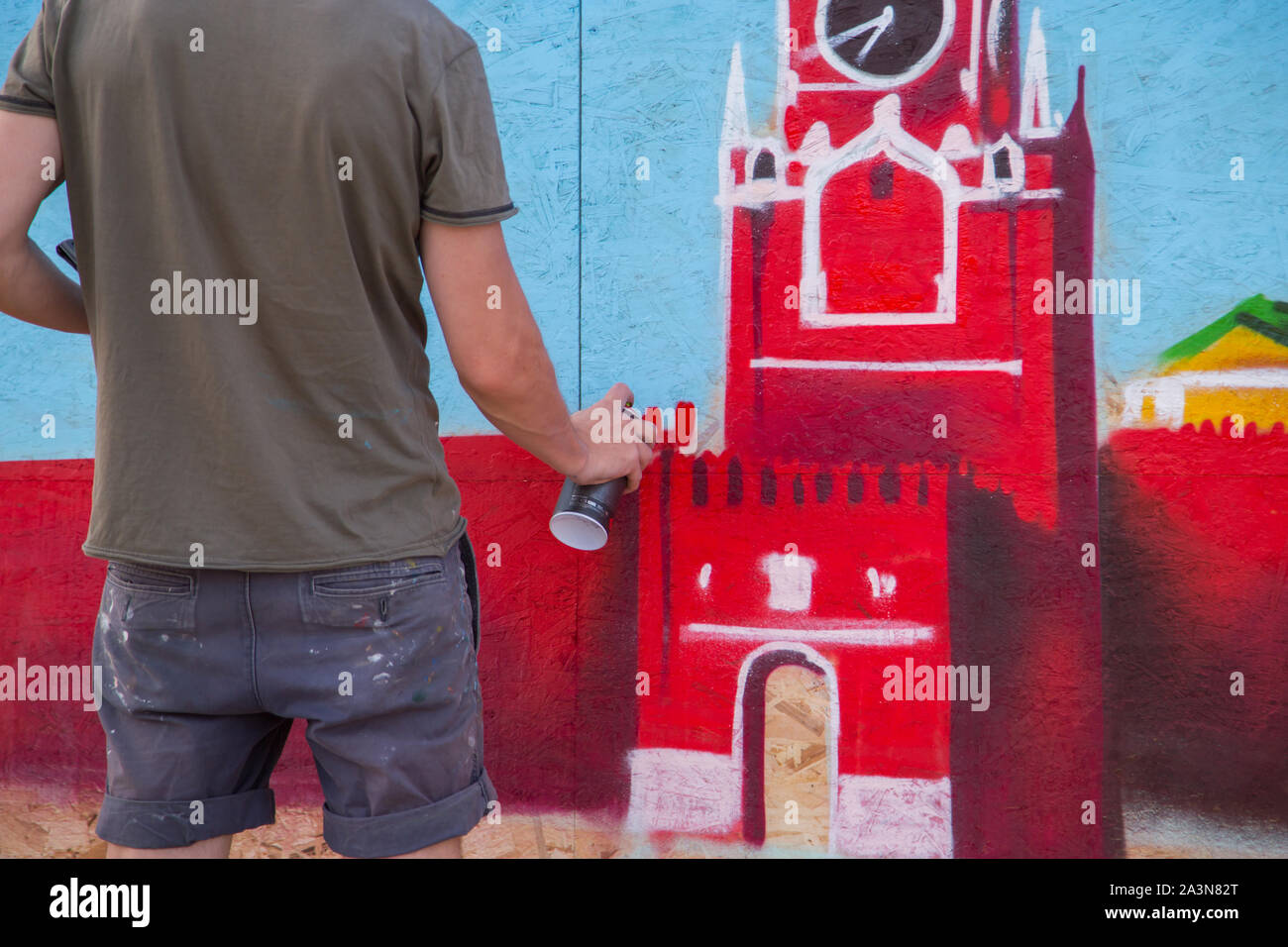 Street artist painting colorful graffiti on public wall Stock Photo - Alamy