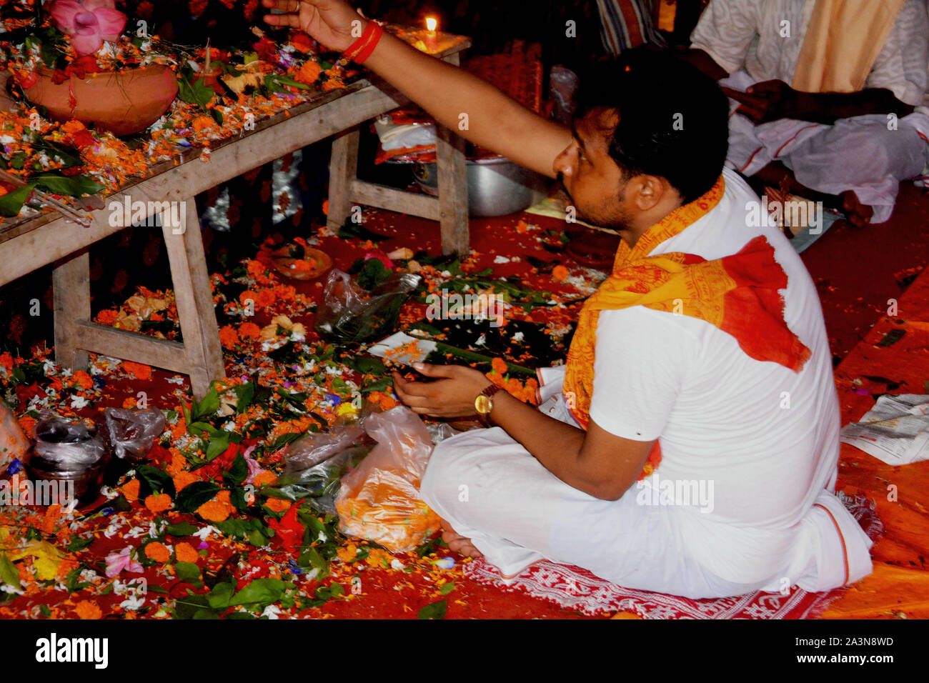 Chanda Bazar, North 24 Parganas, India, 6th October, 2019 :  Hindu priest. Pundit, Brahman reading Hindu mantra in a pandal performing rituals of Puja Stock Photo