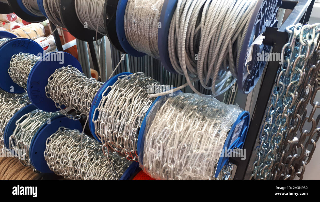 Industrial stainless chains and cables. The steel chain is reeled up on