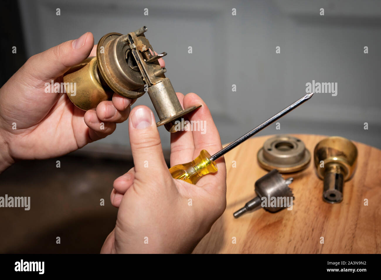 Disassembled doorknob undergoing repair in man's hands Stock Photo
