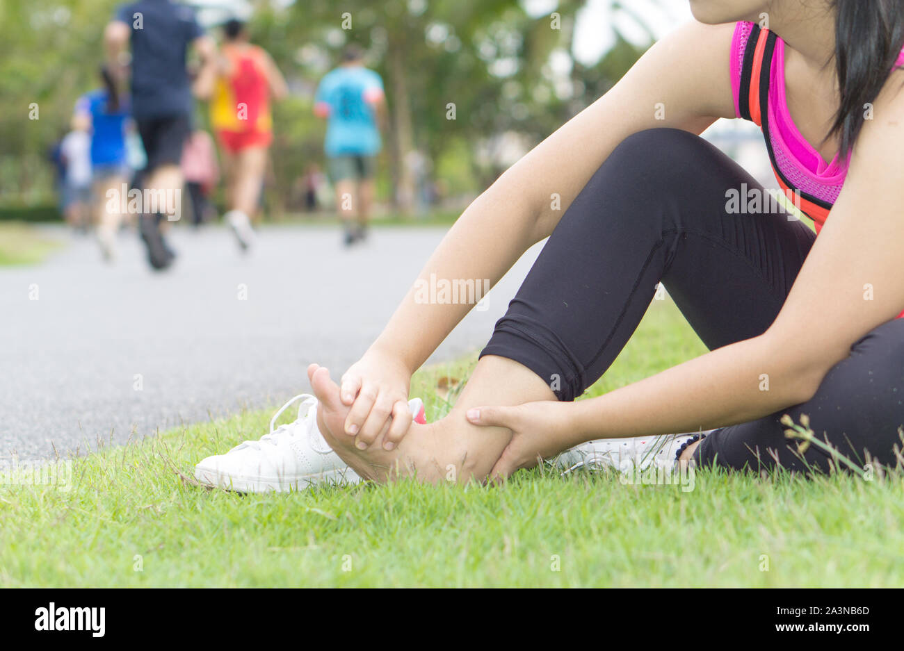 Ankle sprained. Young woman suffering from an ankle injury while