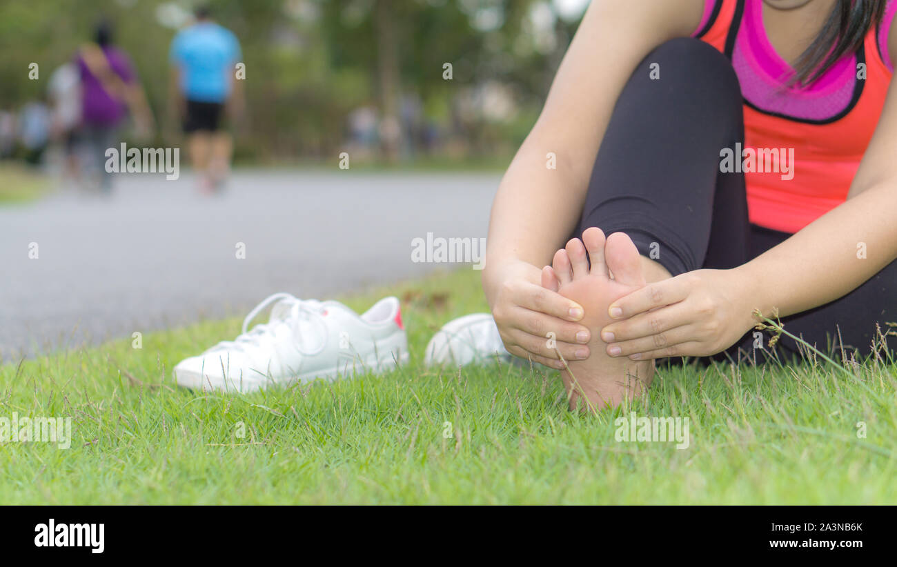 Ankle sprained. Young woman suffering from an ankle injury while