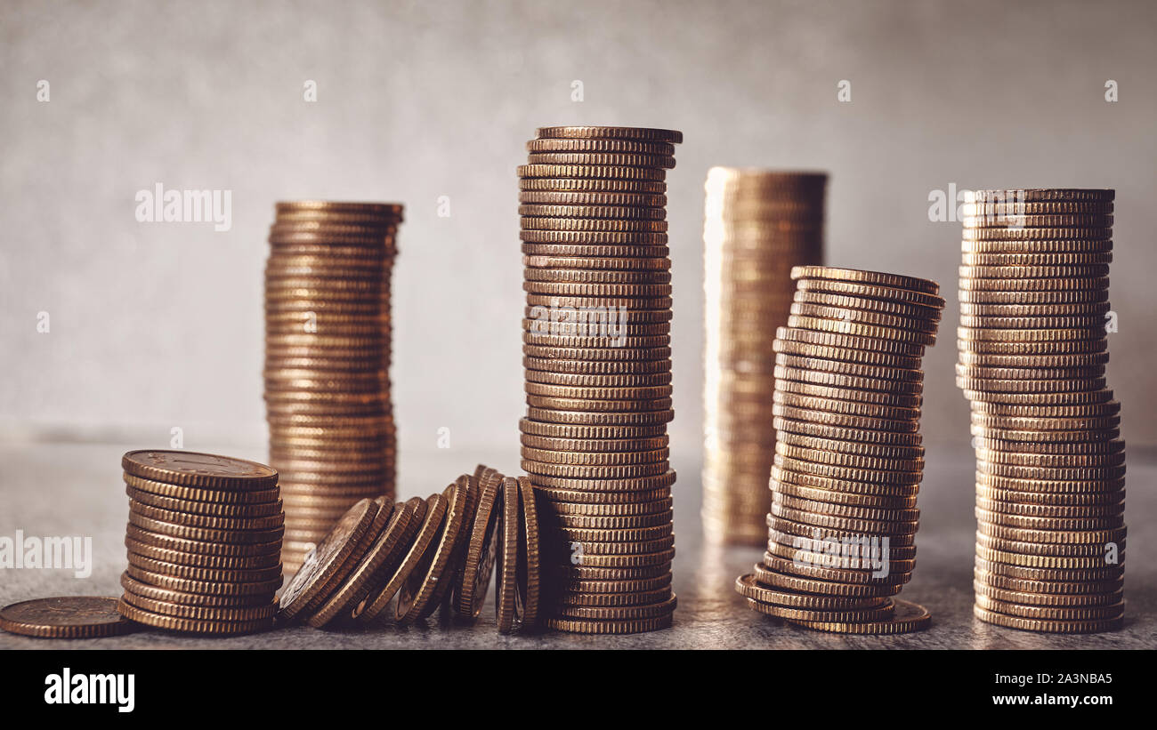 Stacks of golden coins, shallow depth of field, color toning applied. Stock Photo