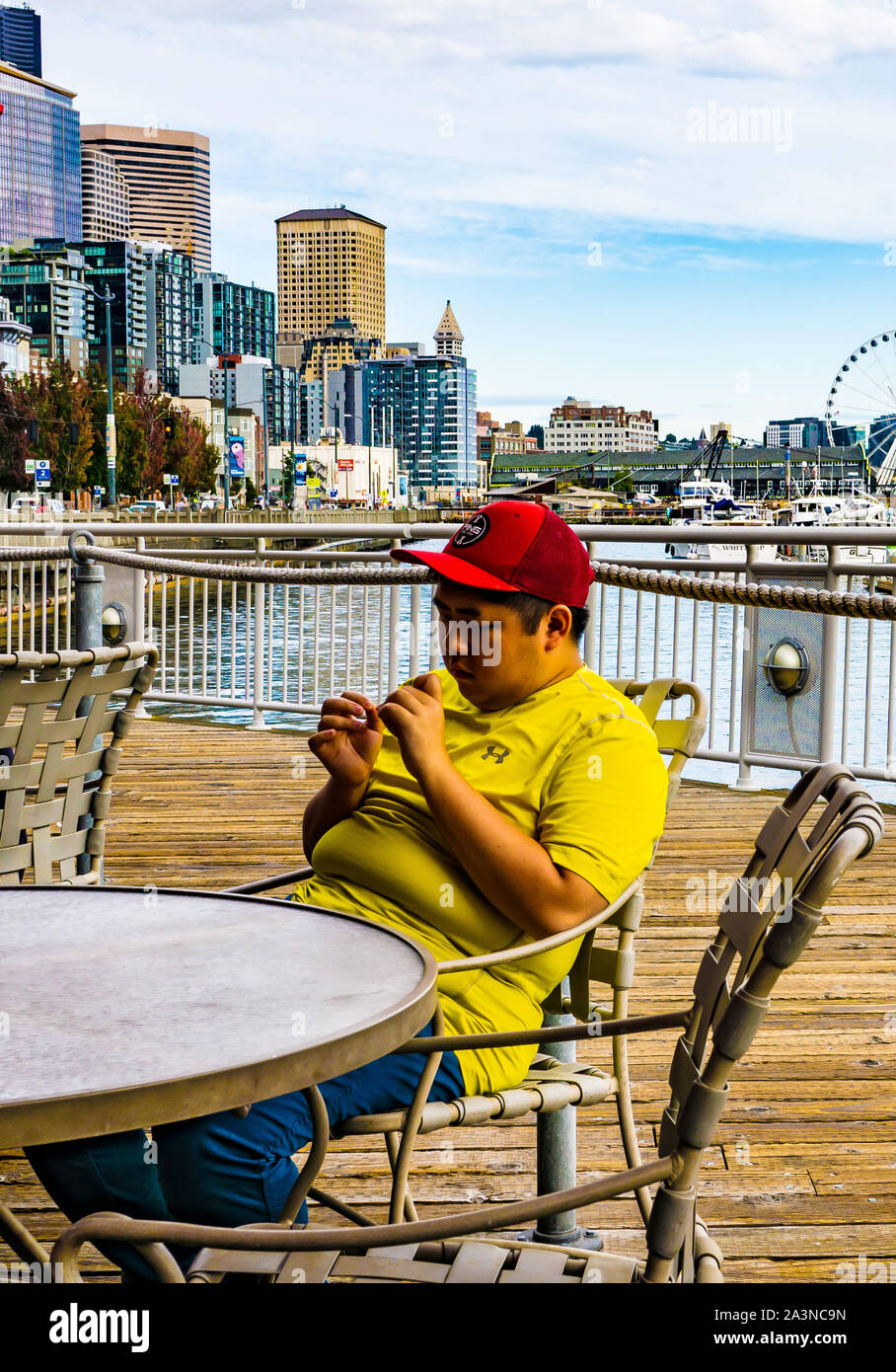 Teenager chilling on Seattle Promenade Stock Photo