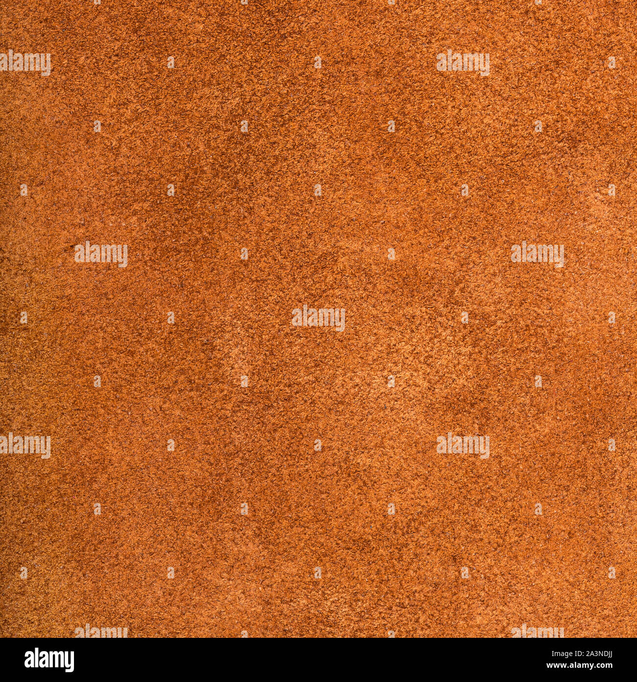 textured square background from dark orange suede close up Stock Photo