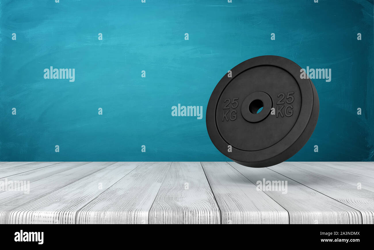 3d rendering of 25 kg weight plate on white wooden floor and dark turquoise background Stock Photo