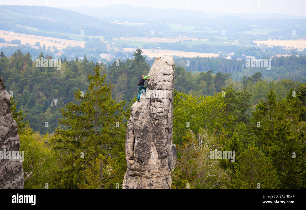 mountain climber at the top,climbing, Prachovske skaly, Czech Republic, A unique combination of outlandish rock formations Stock Photo
