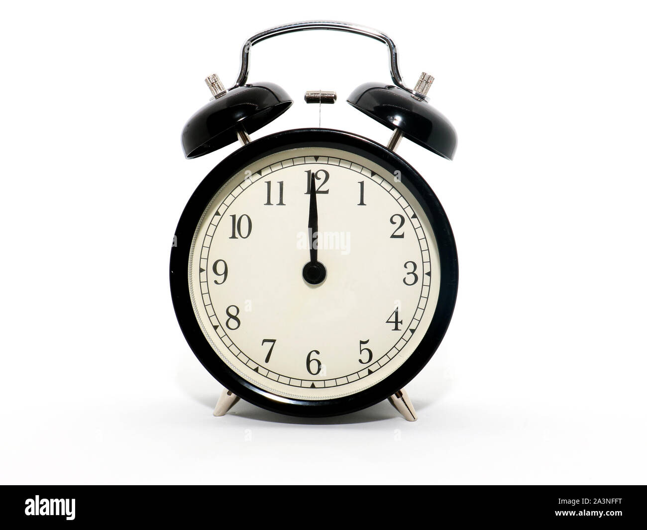 Old-style alarm clock, black and white, it's twelve o'clock. Stock Photo