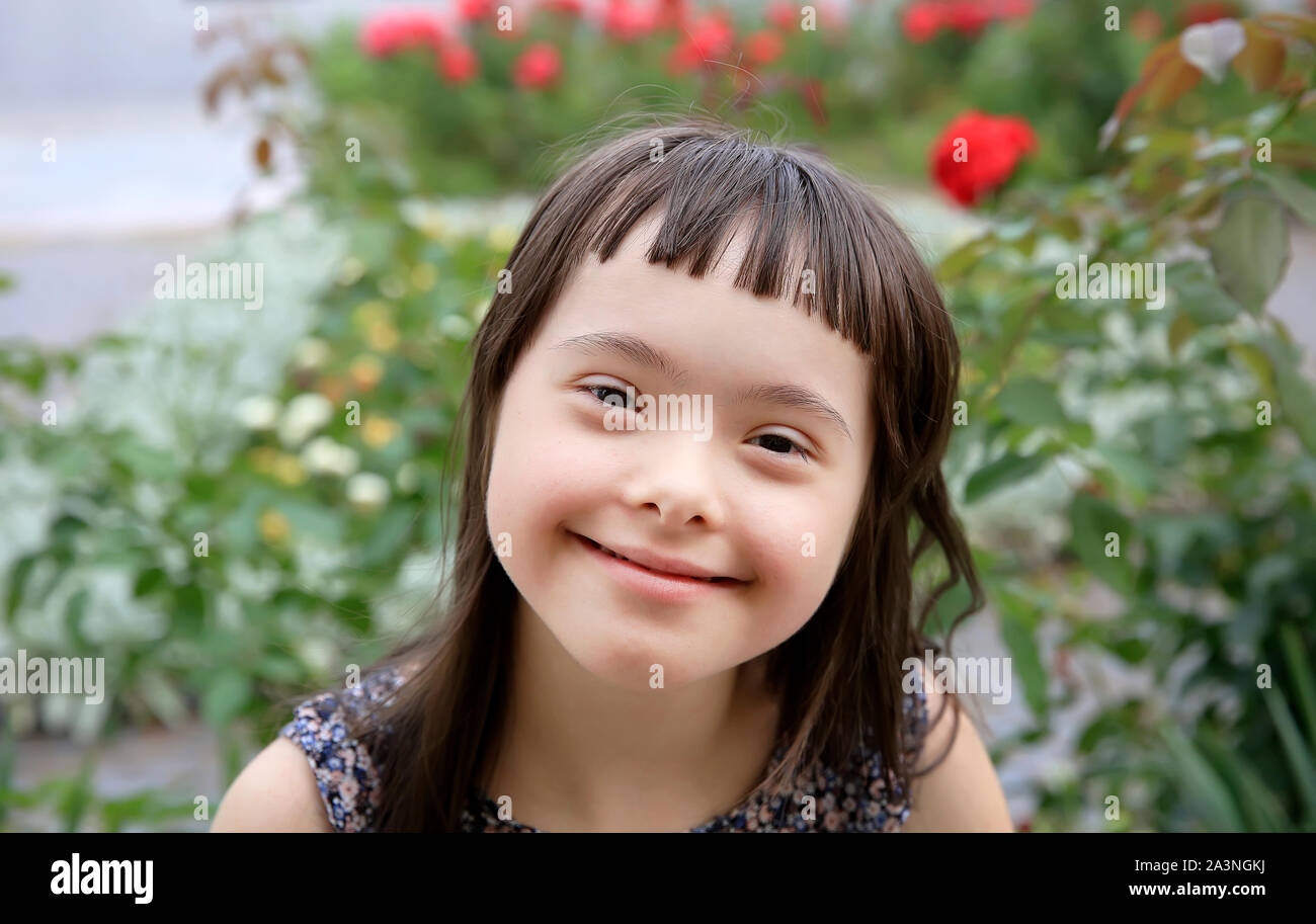 Portrait of little girl smiling in the garden Stock Photo - Alamy