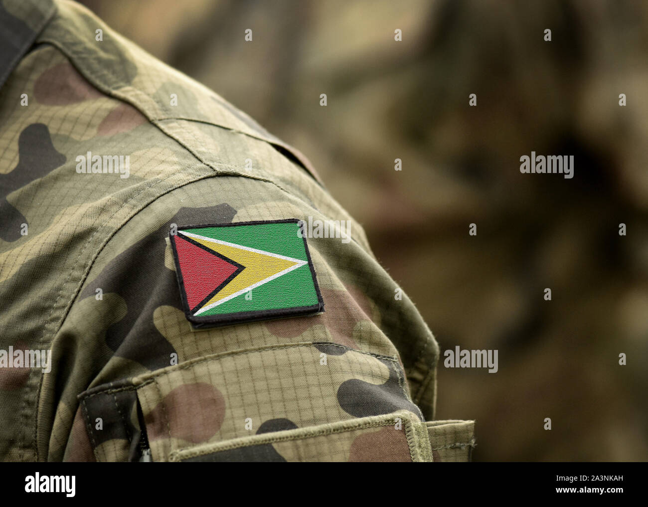 Flag of Guyana on on military uniform. Flag of Co-operative Republic of Guyana on military uniforms. Army, troops, soldier (collage). Stock Photo