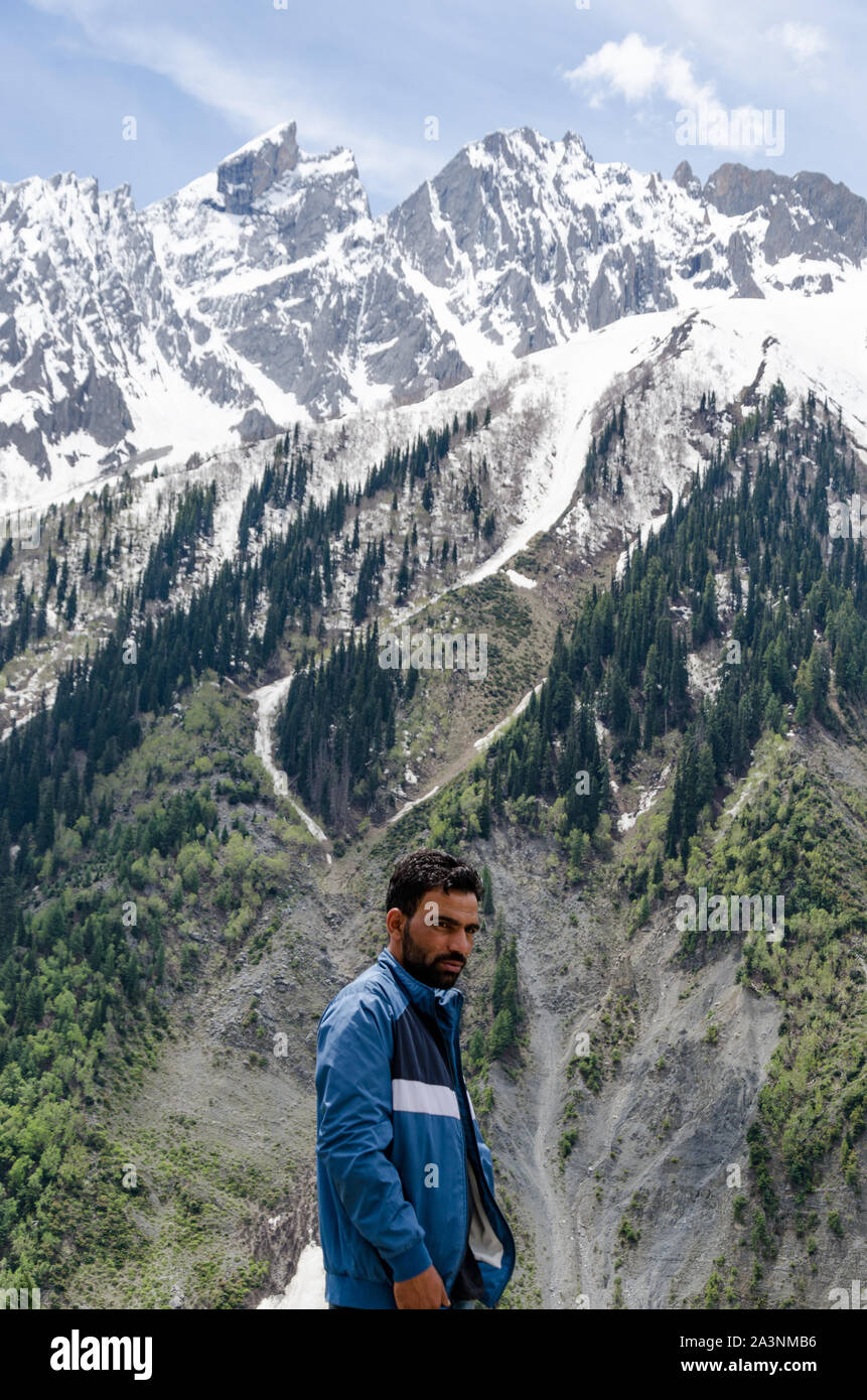 Portrait of a local Kashmiri man against backdrop of snowcapped mountains. Stock Photo