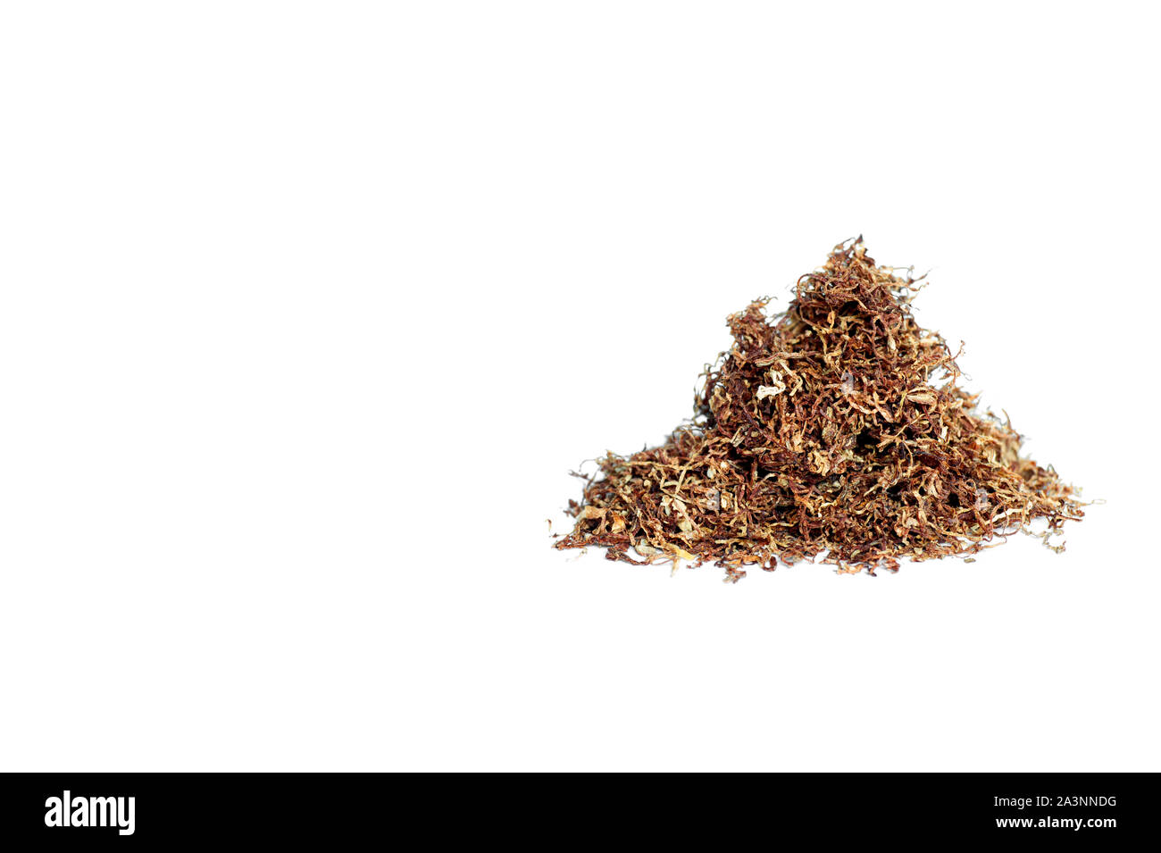 A slide of brown cigarette tobacco thinly sliced isolated on a white  background. The concept of the content of natural tobacco and impurities in  the p Stock Photo