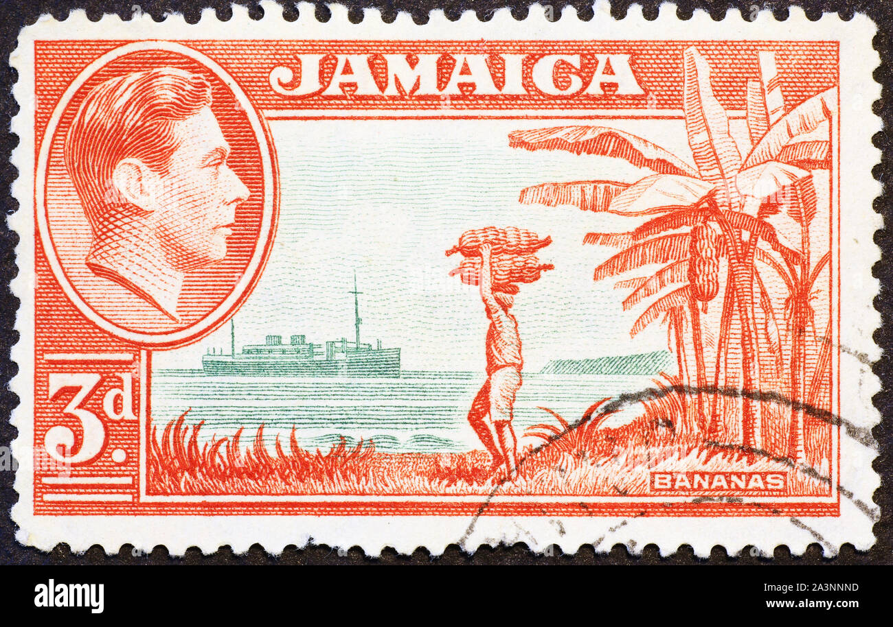 Man carrying bananas on vintage postage stamp of Bahamas Stock Photo