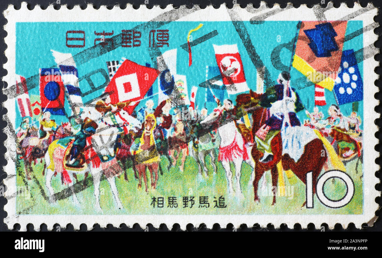 Painting of an ancient horse chase on japanese stamp Stock Photo