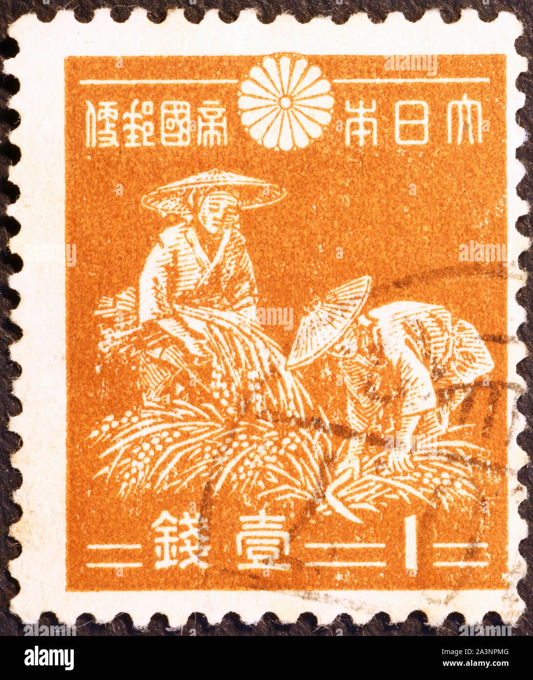 Two women harvesting rice on old japanese postage stamp Stock Photo