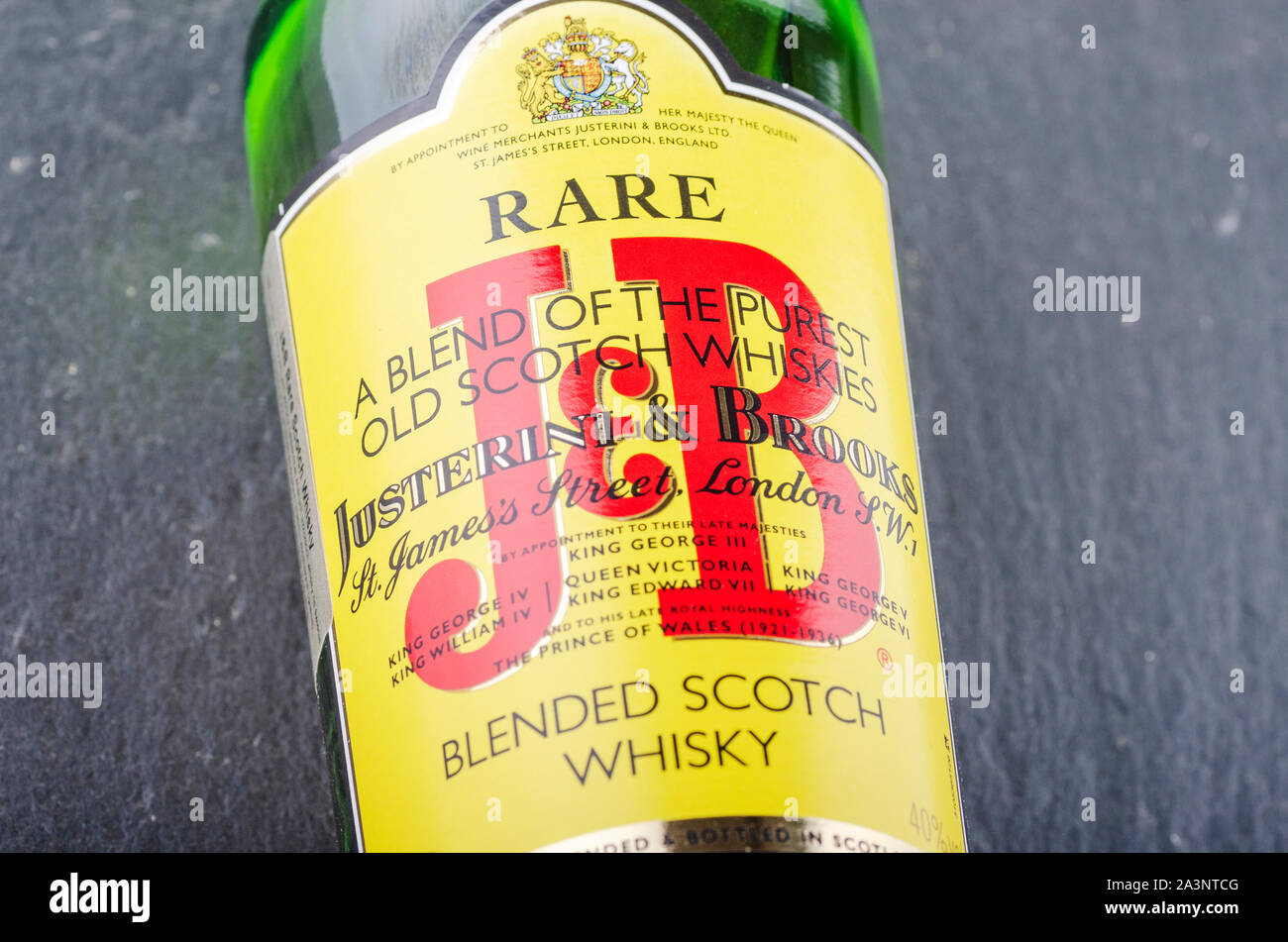 J&B blended scotch whisky on stone slate background. Justerini and
