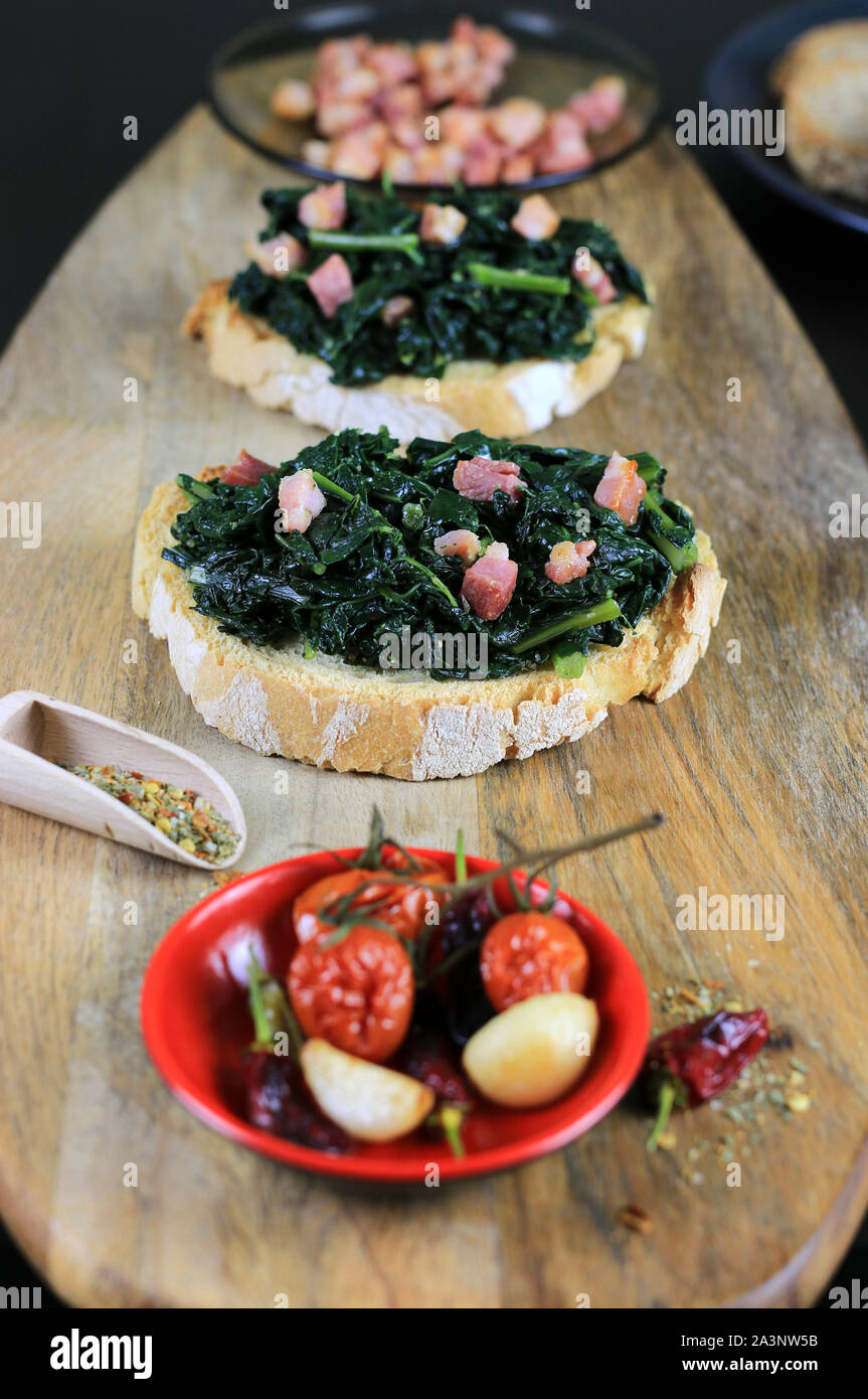 Concept of Italian food. Bruschetta with black cabbage and bacon on