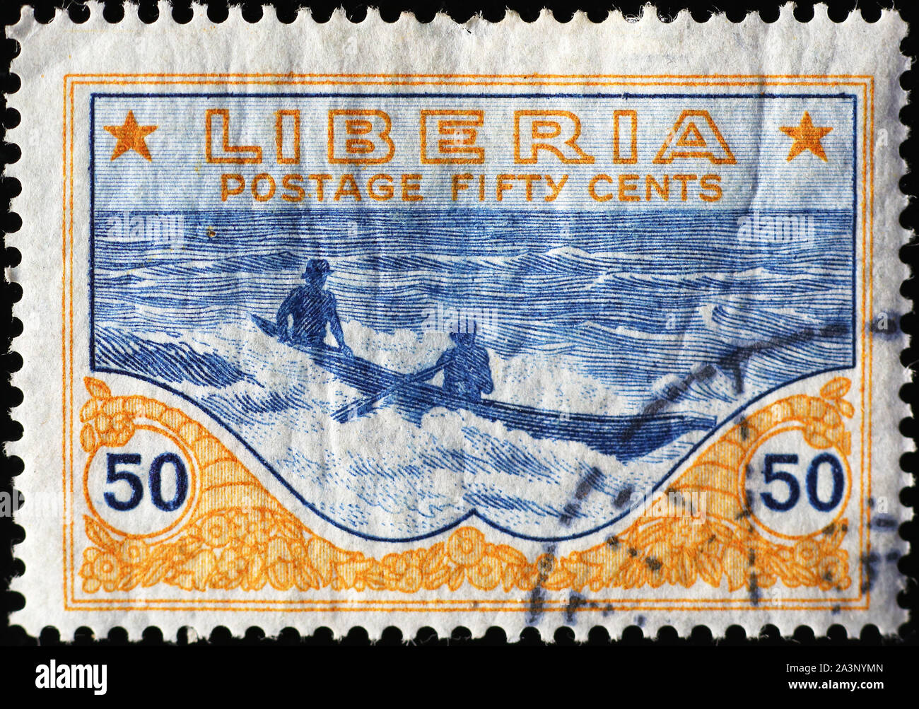 Two men in canoe on vintage stamp of Liberia Stock Photo