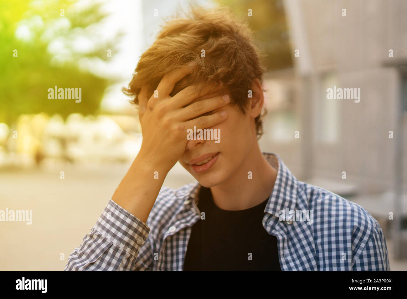 young man facepalm gesture emotion, frustrated man cover the face with hands Stock Photo