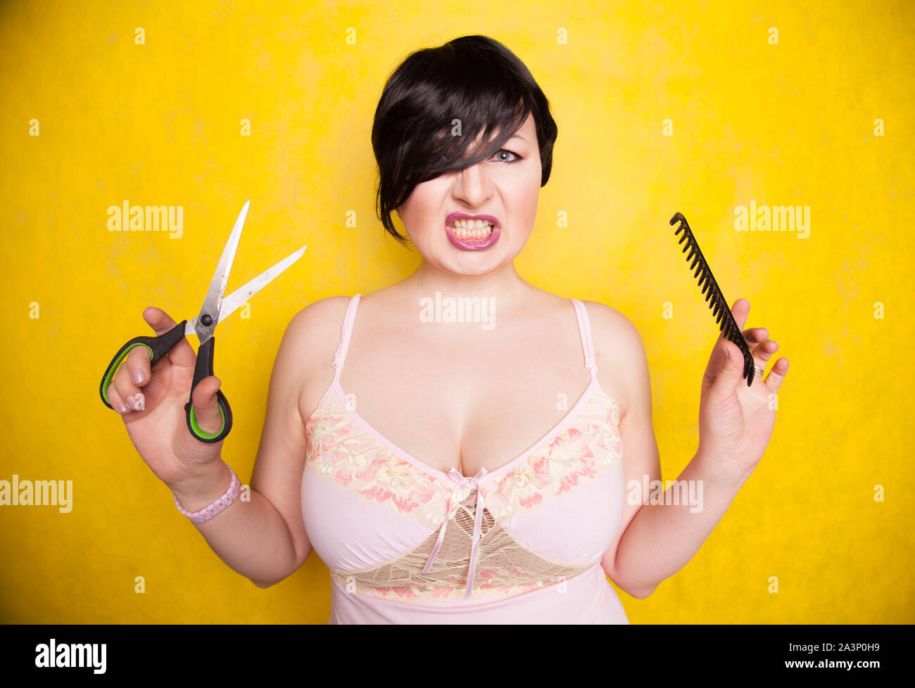 charming emotional plus size woman cuts her hair with scissors because
