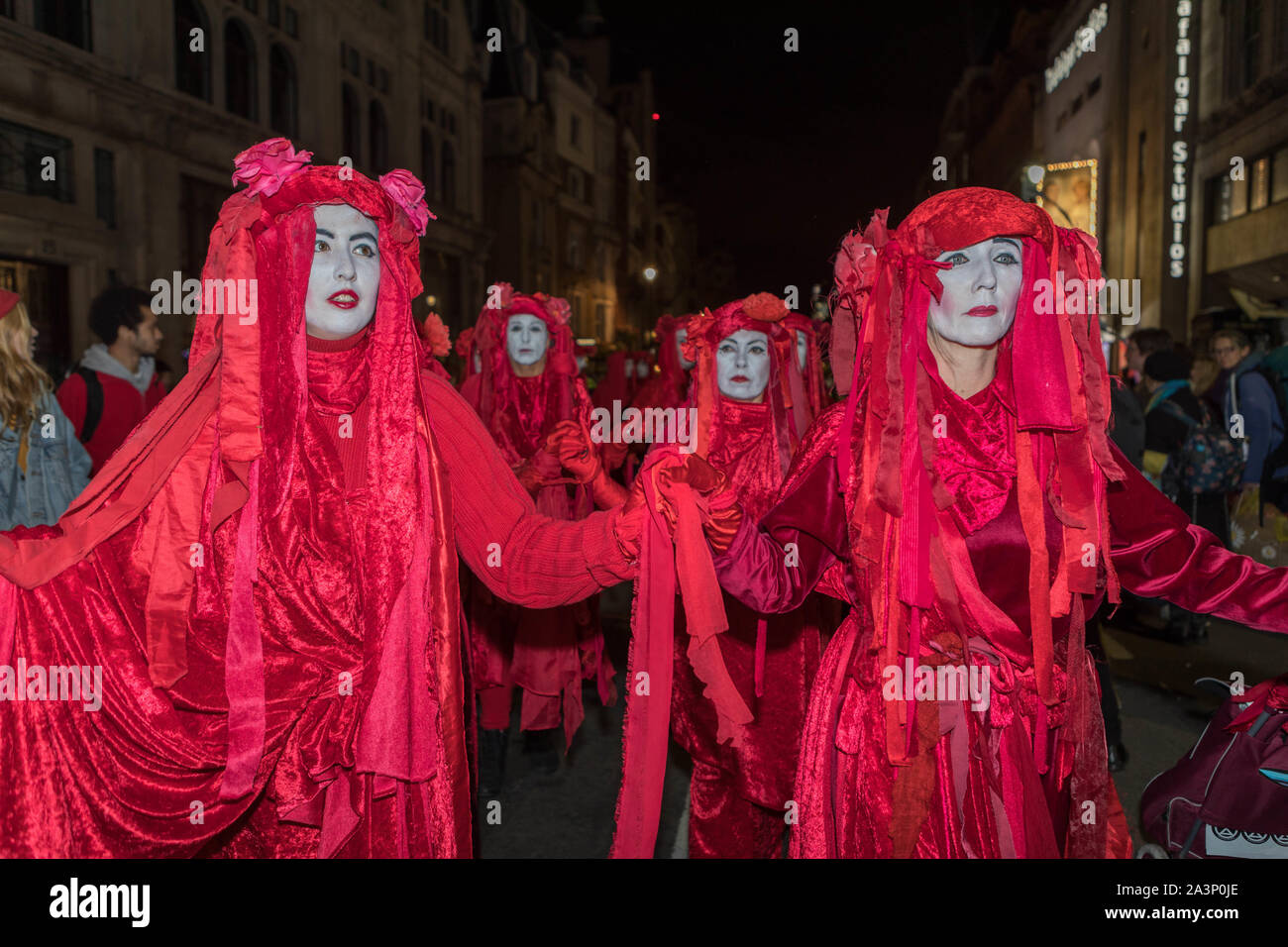 Trafalgar Square, London, UK. 9th Oct, 2019. The Red Brigade, also known as the Invisible circus, join the Extinction Rebellion protest at Trafalgar Square. Penelope Barritt/alamy Live News Stock Photo