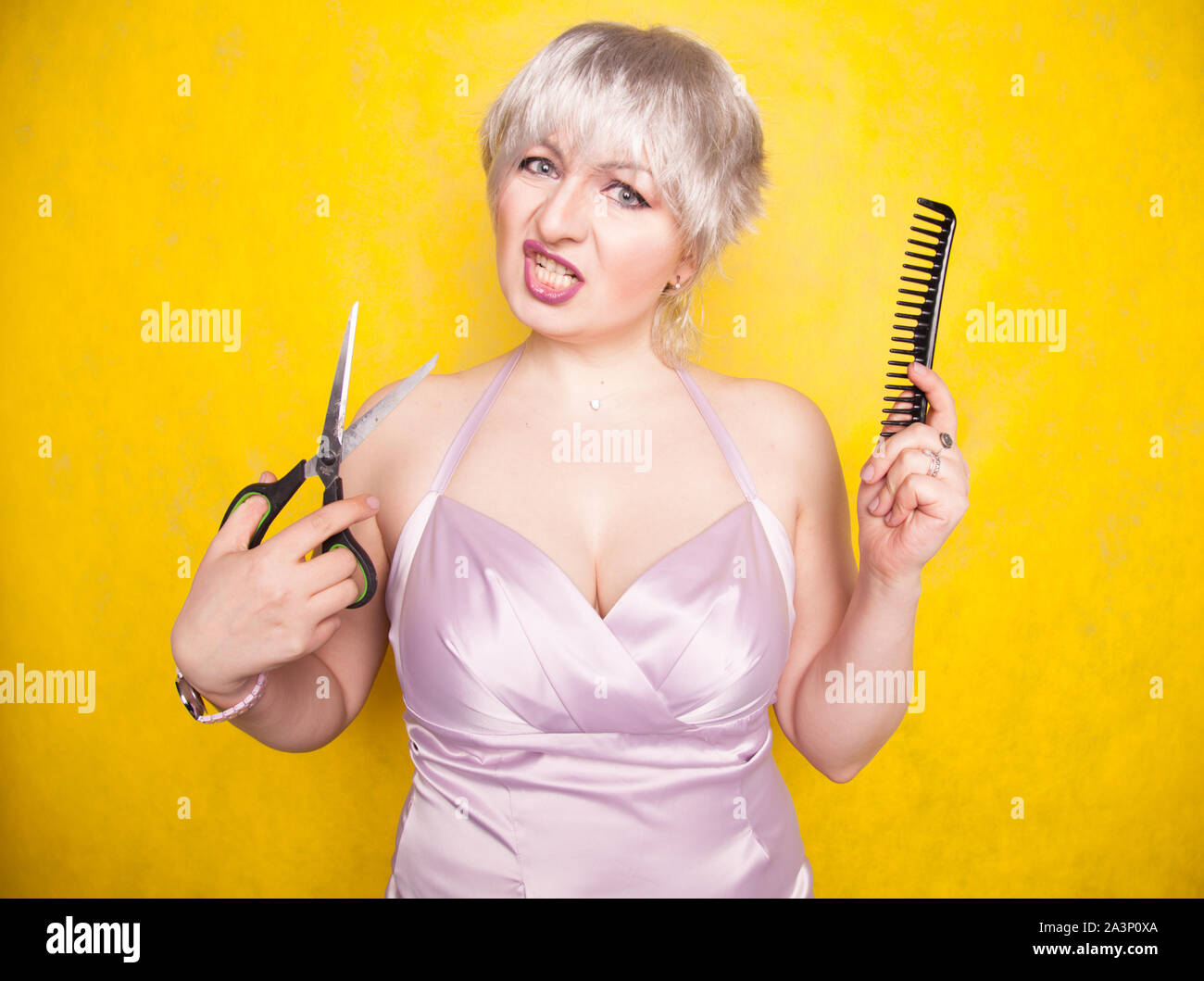 charming emotional plus size woman cuts her hair with scissors because