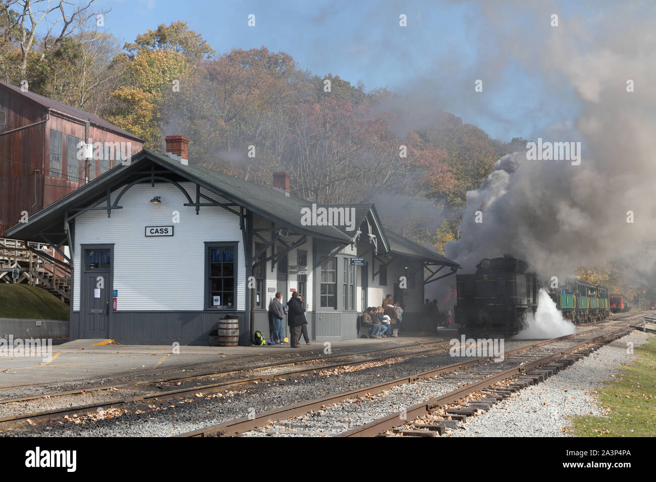 Smoke from a direct-gear logging locomotive nearly obscures the depot at Cass Scenic Railroad State Park in Cass, West Virginia Stock Photo