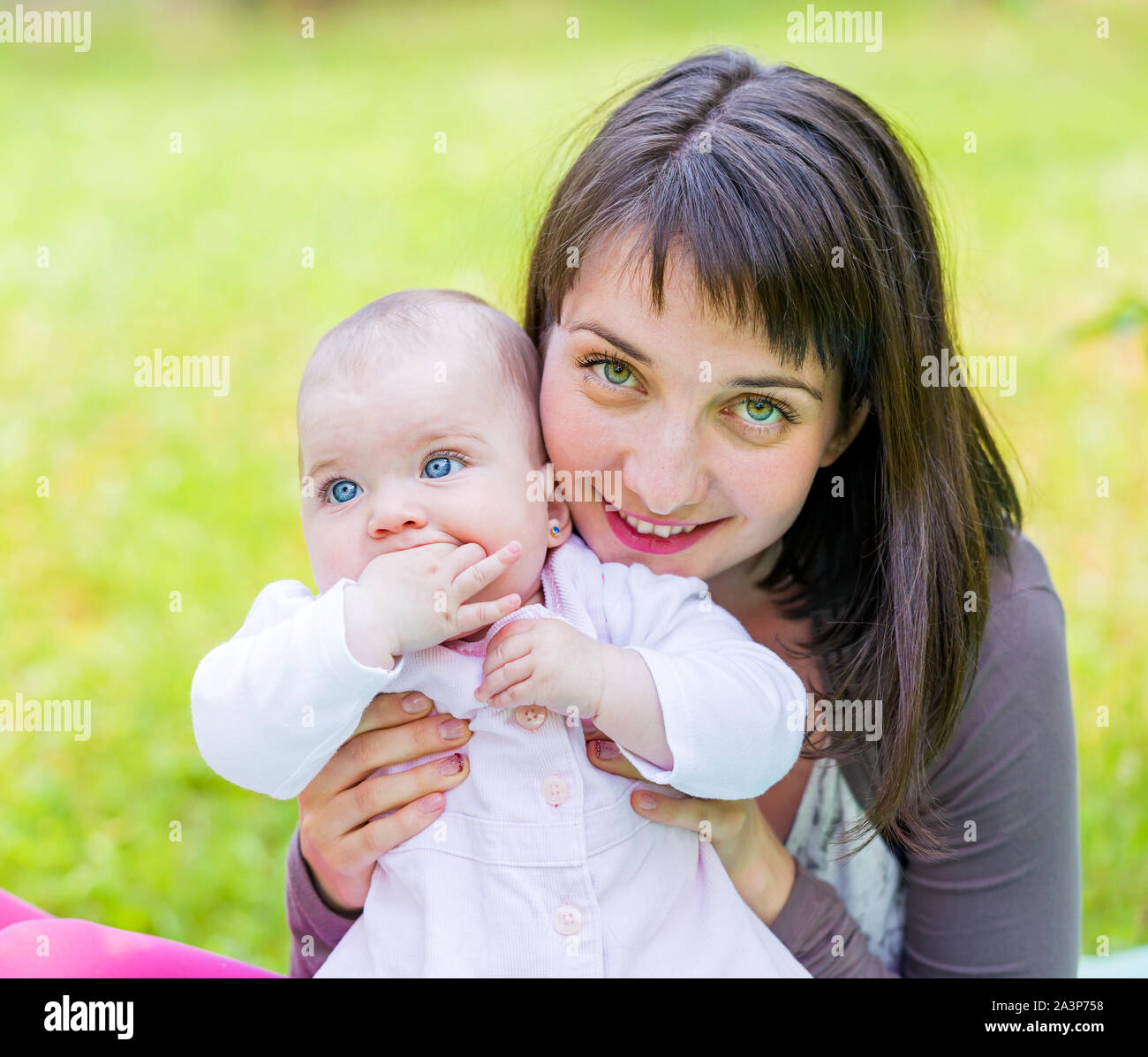 Portrait of an adorable baby with her mother Stock Photo - Alamy