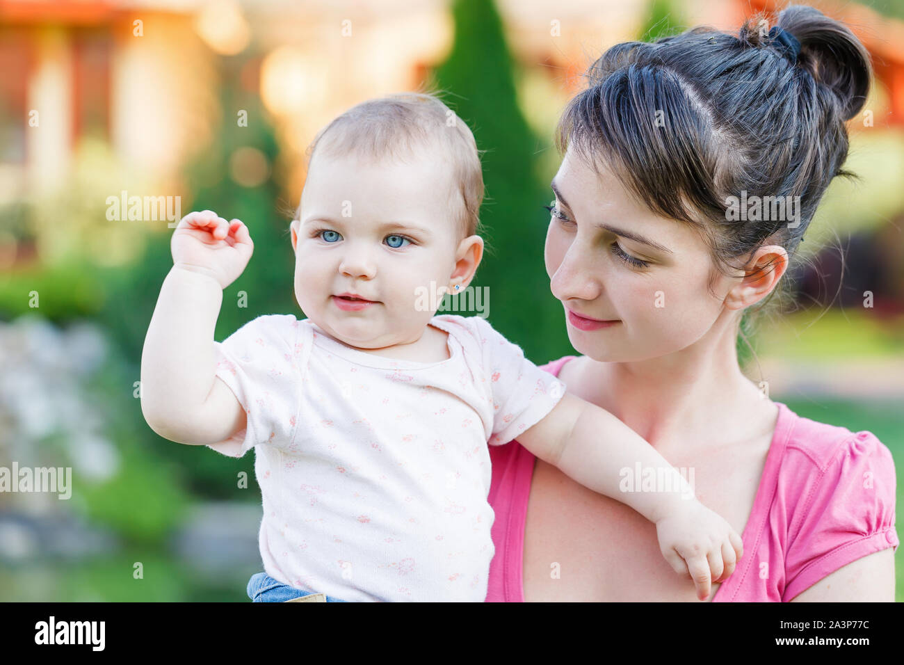 Portrait of an adorable baby with her mother Stock Photo - Alamy