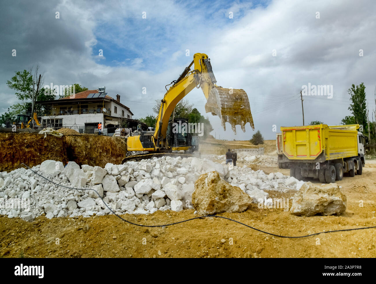 Excavator work at a construction site. Excavator digs a hole Stock ...