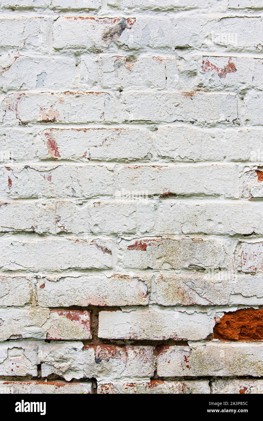 Old wall, cracked and dirty, bricks. White color vertical design background. Stock Photo
