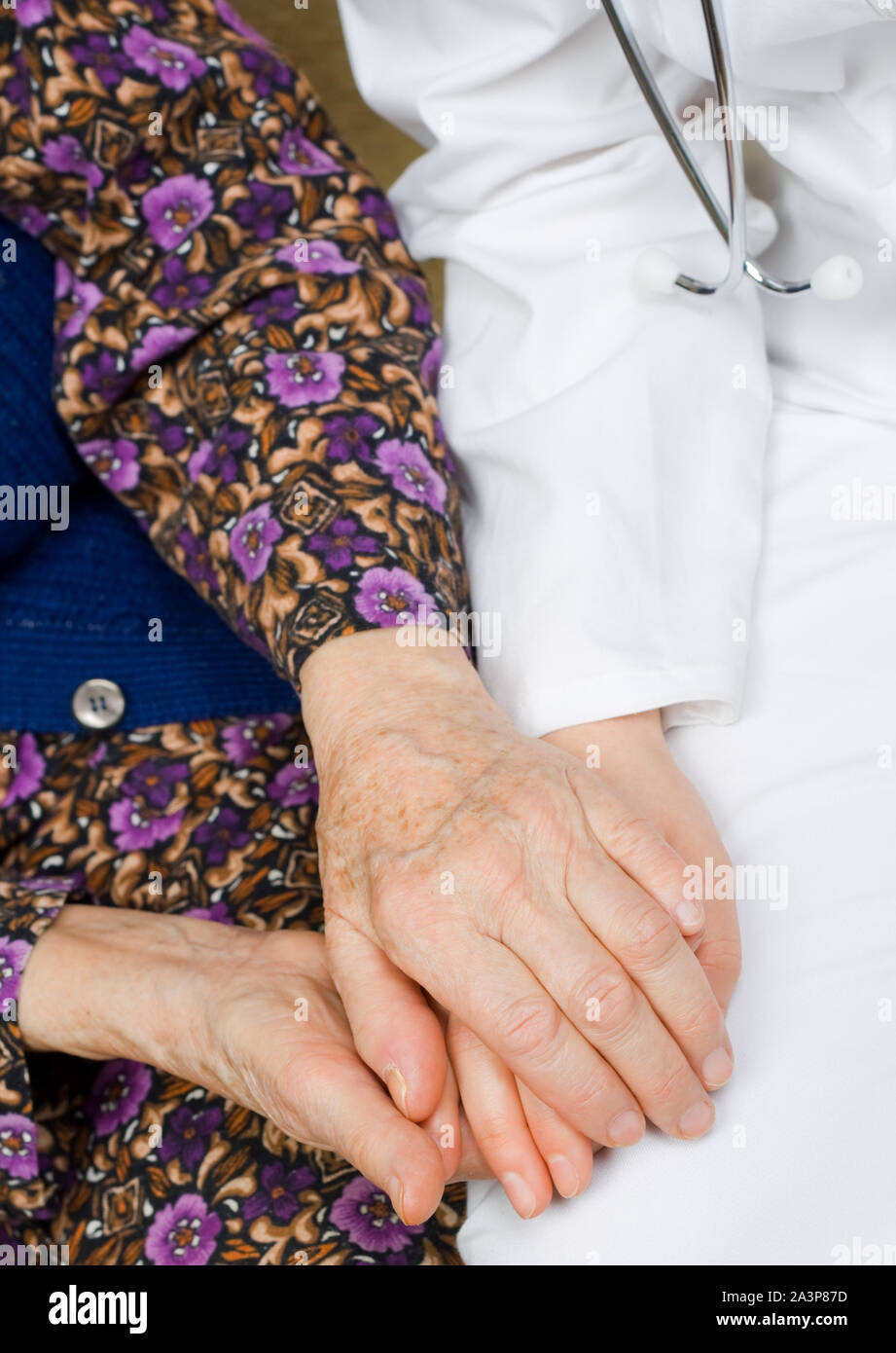 Elderly woman holds the doctor's hands. Stock Photo