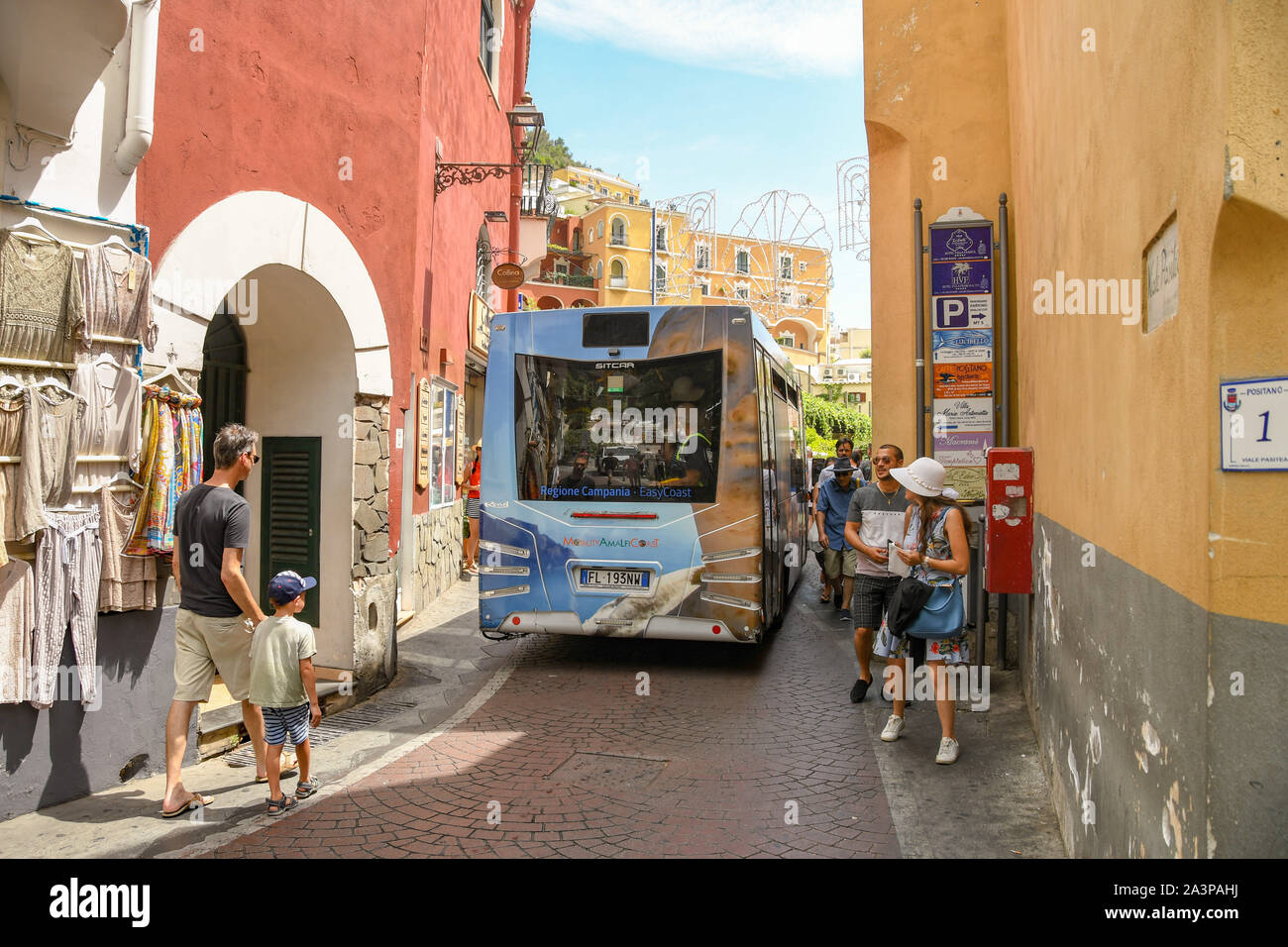 POSITANO, ITALY - AUGUST 2019: Bus full of people negotiating one of the narrow streets in the town of Positano on Italy's Amalfi Coast Stock Photo