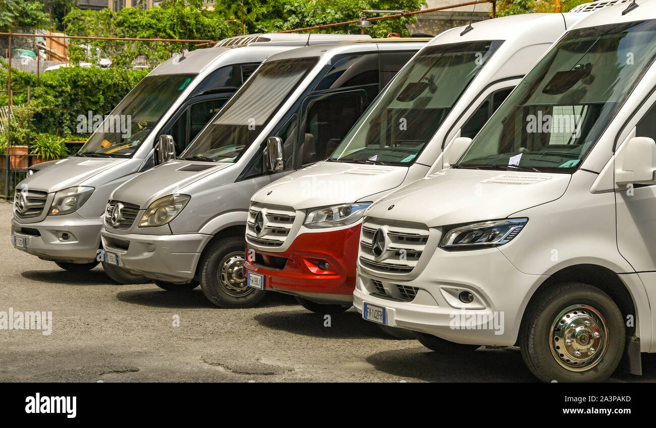 POSITANO, ITALY - AUGUST 2019: Row of small Mercedes motor coaches parked in the town of Positano on Italy's Amalfi Coast Stock Photo