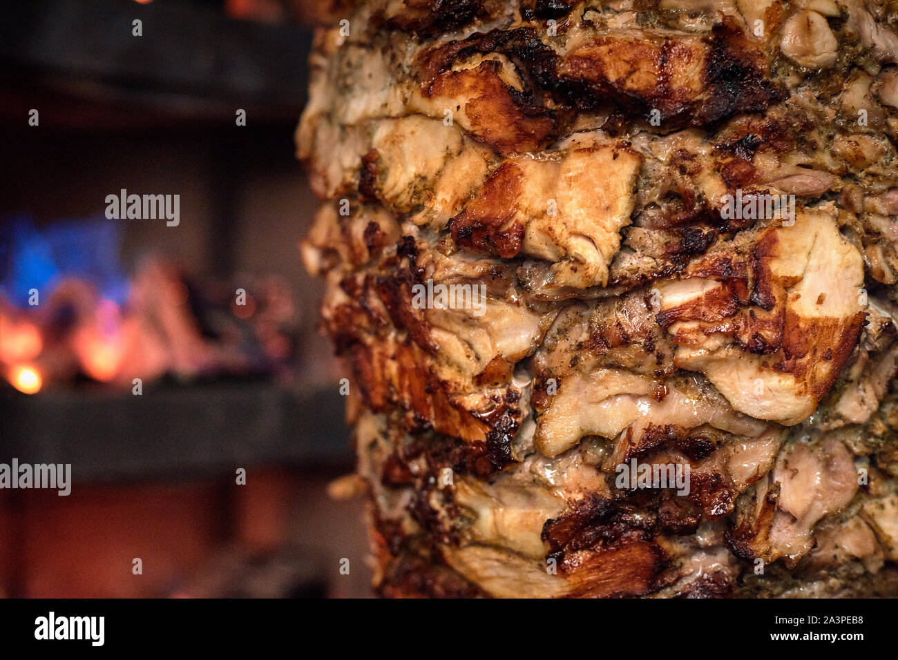 Charcoal shawarma meat. Closeup of chicken meat collected on a vertical